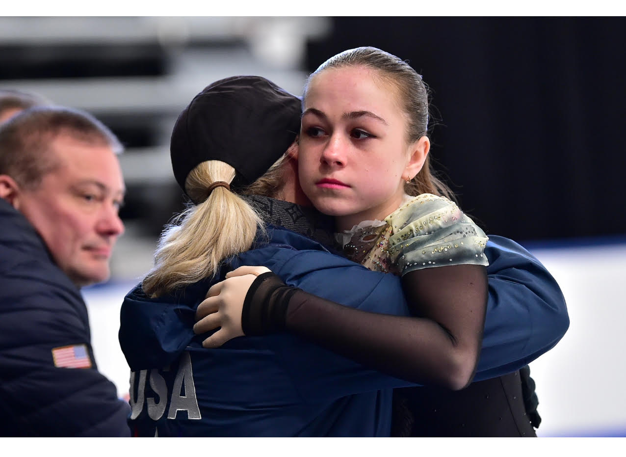 Von Felten embraces coach Olga Ganicheva rinkside.