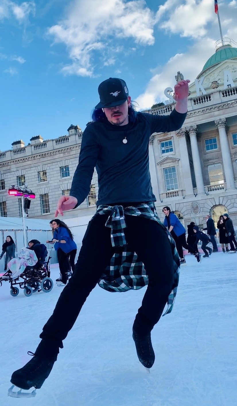 Adam Blake dancing on an outdoor ice rink.