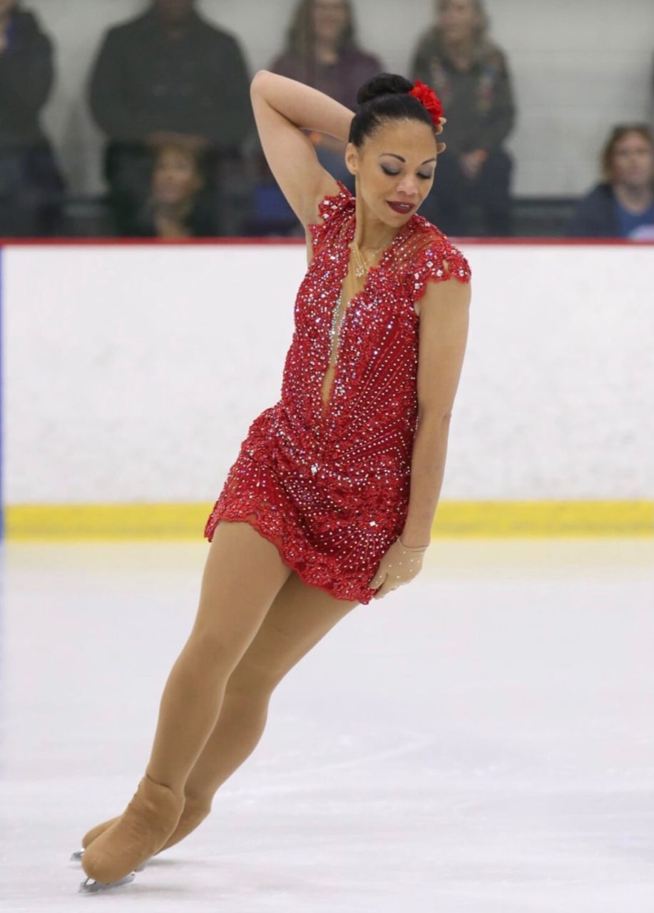 Arlanna Moshfeghi skating in a sequined dress.