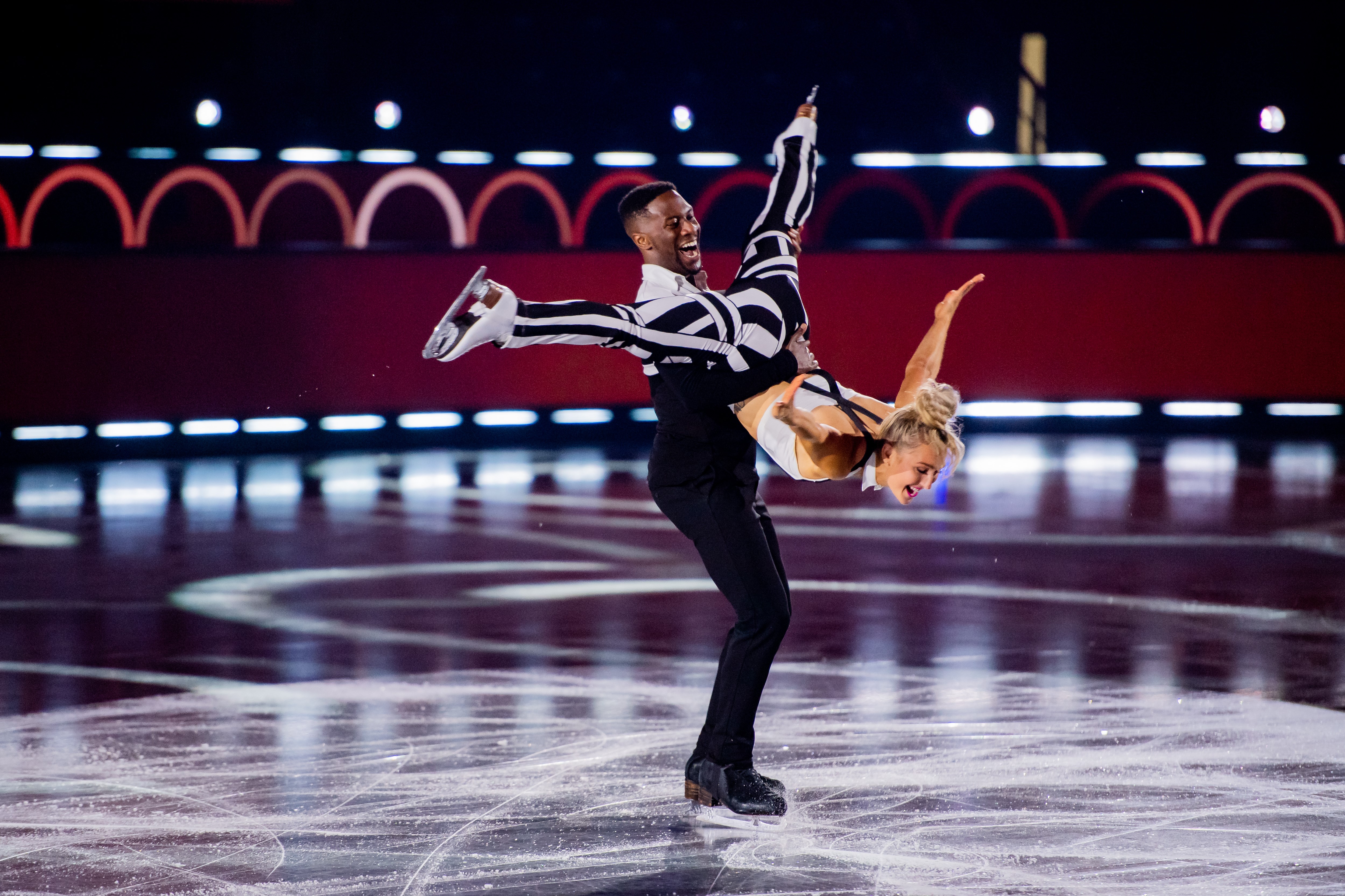 Asher Hill competes with a partner on Battle of the Blades, performing a spiral pair spin.