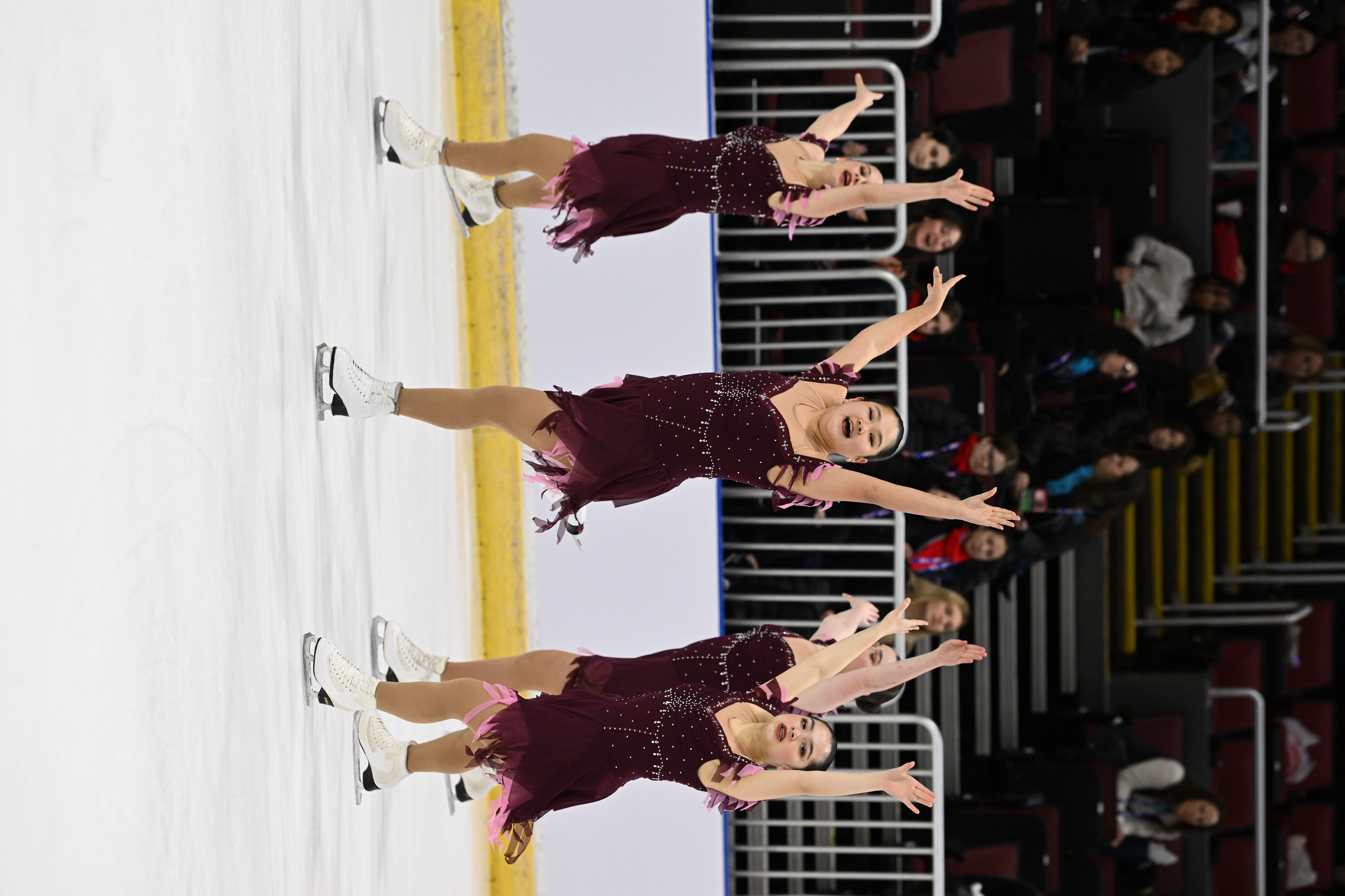 Team Image competes in the novice division at the 2023 U.S. Synchronized Skating Championships. The group skates in matching dark red costumes with their arms up in the air
