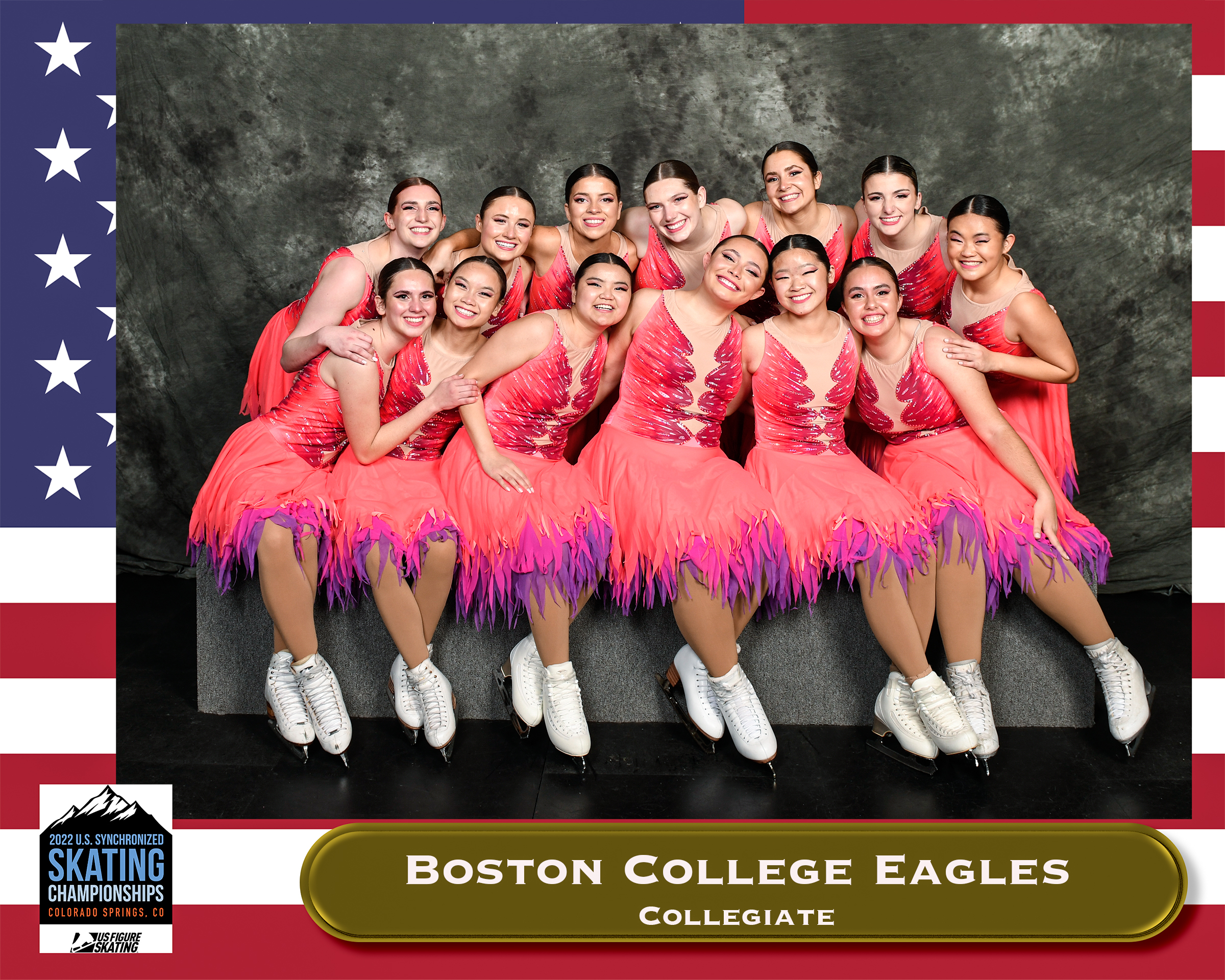 Skaters in pink dresses in a group photo with a frame labeled 2022 U.S. Synchronized Skating Championships.