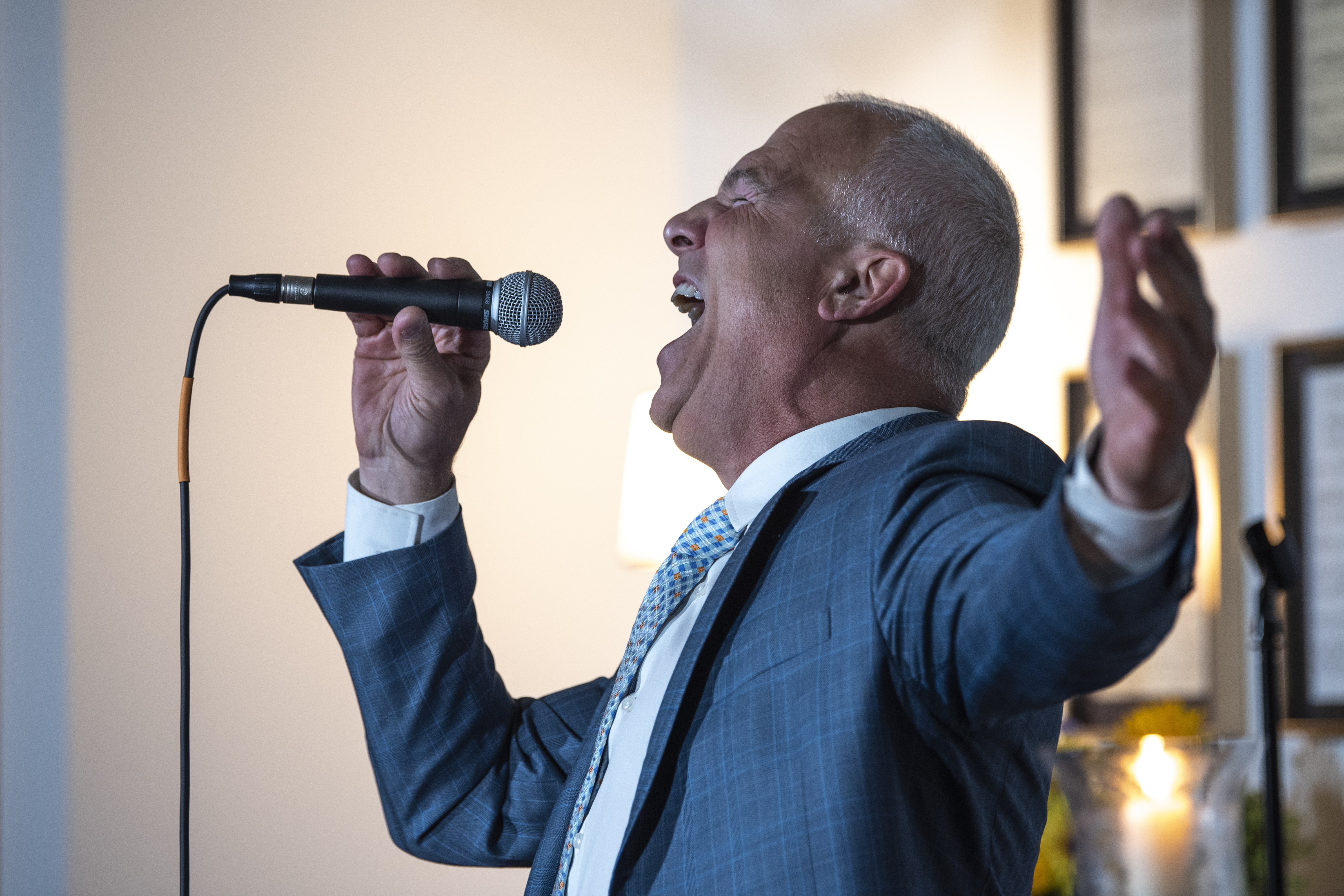 Franc D’Ambrosio sings into a microphone.