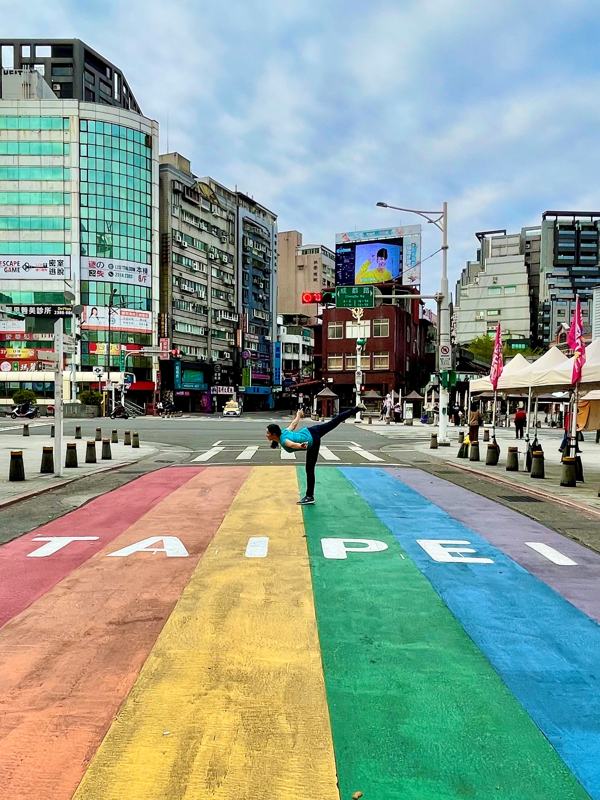 Eva Meyer performs a spiral position on the rainbow painted crosswalk at Ximending