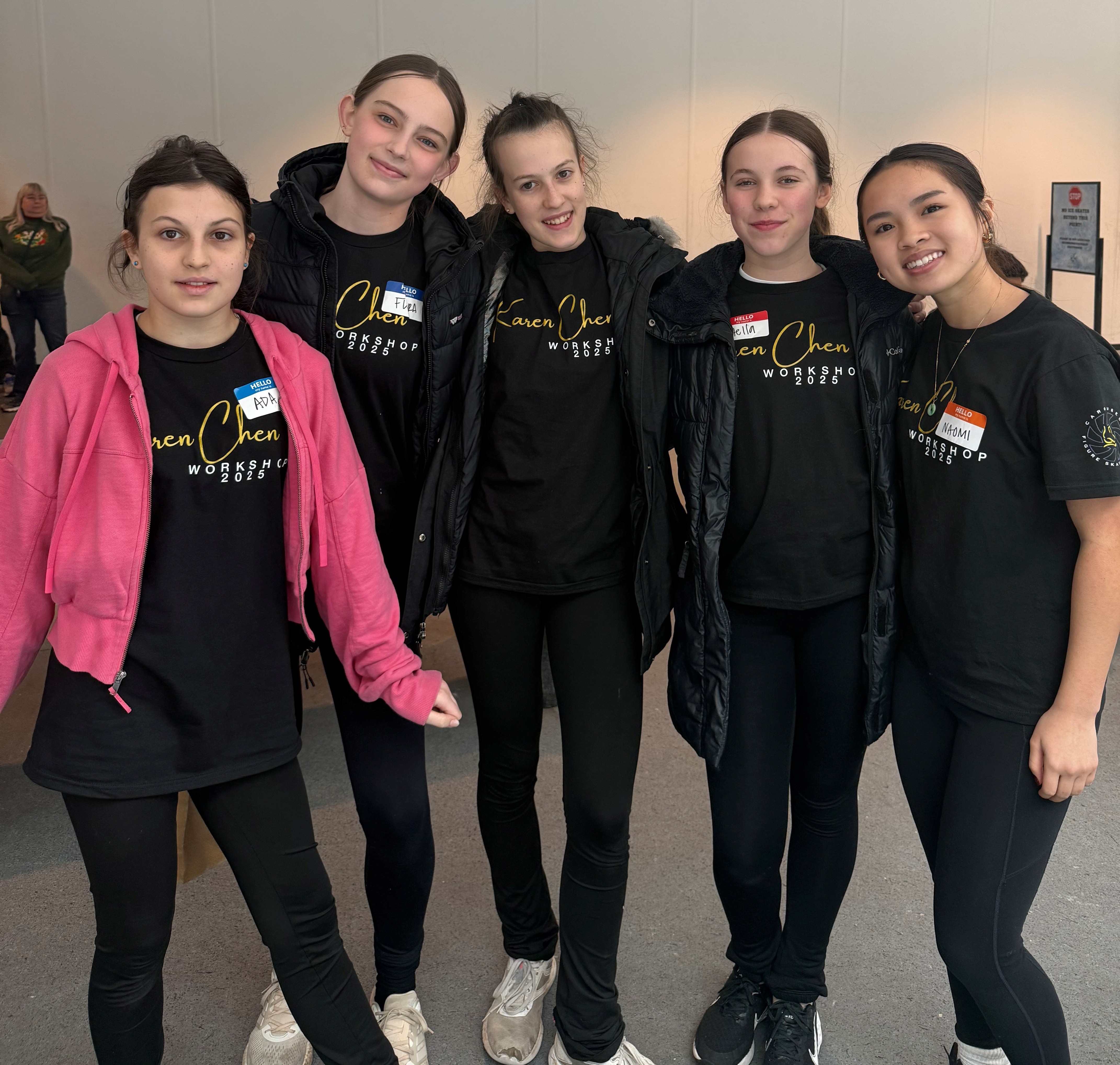 A group of Pacific Ice Academy skaters wearing black attire on the ice