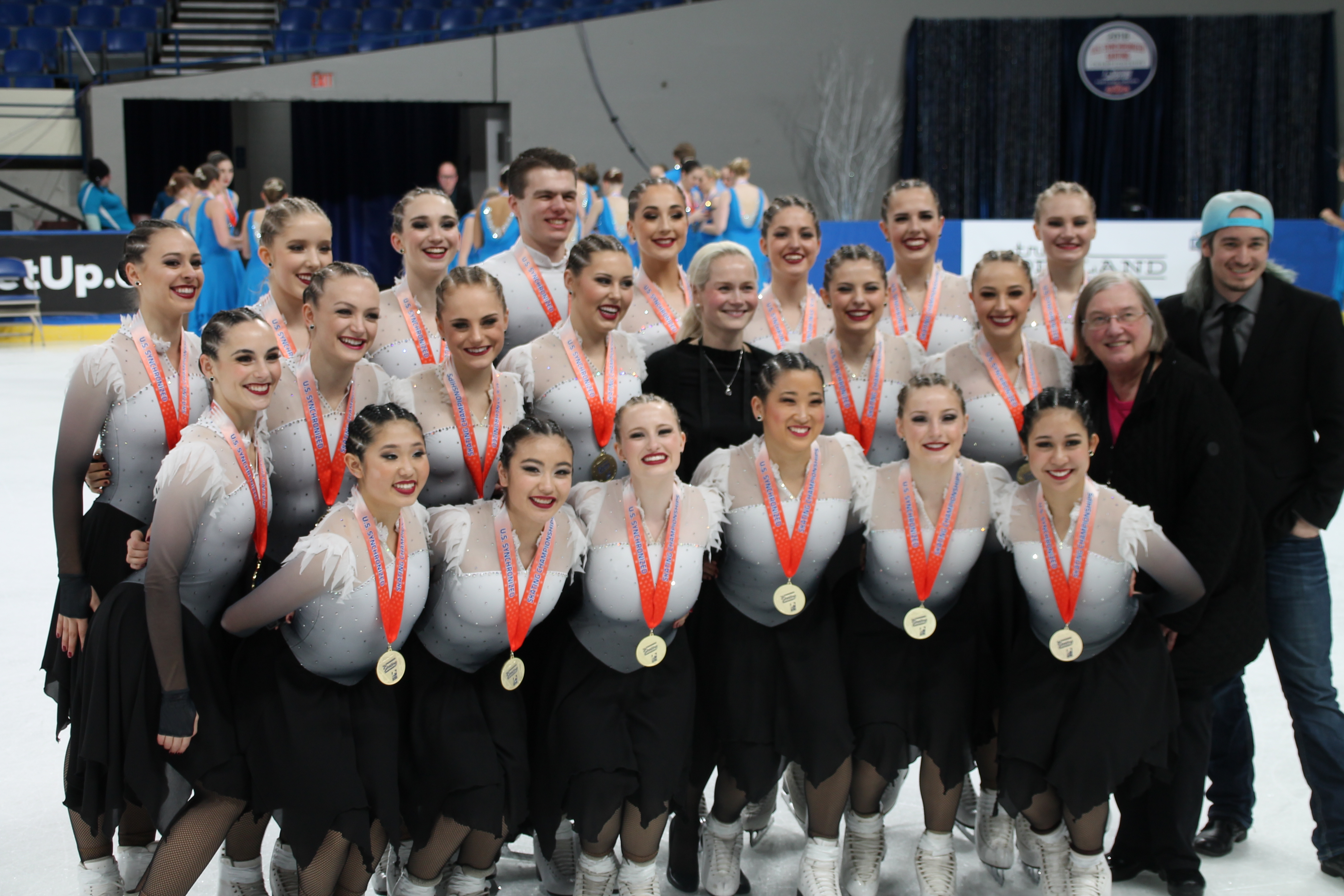 Gail Hanson-May with the Haydenettes on the ice in their costumes at an awards ceremony.