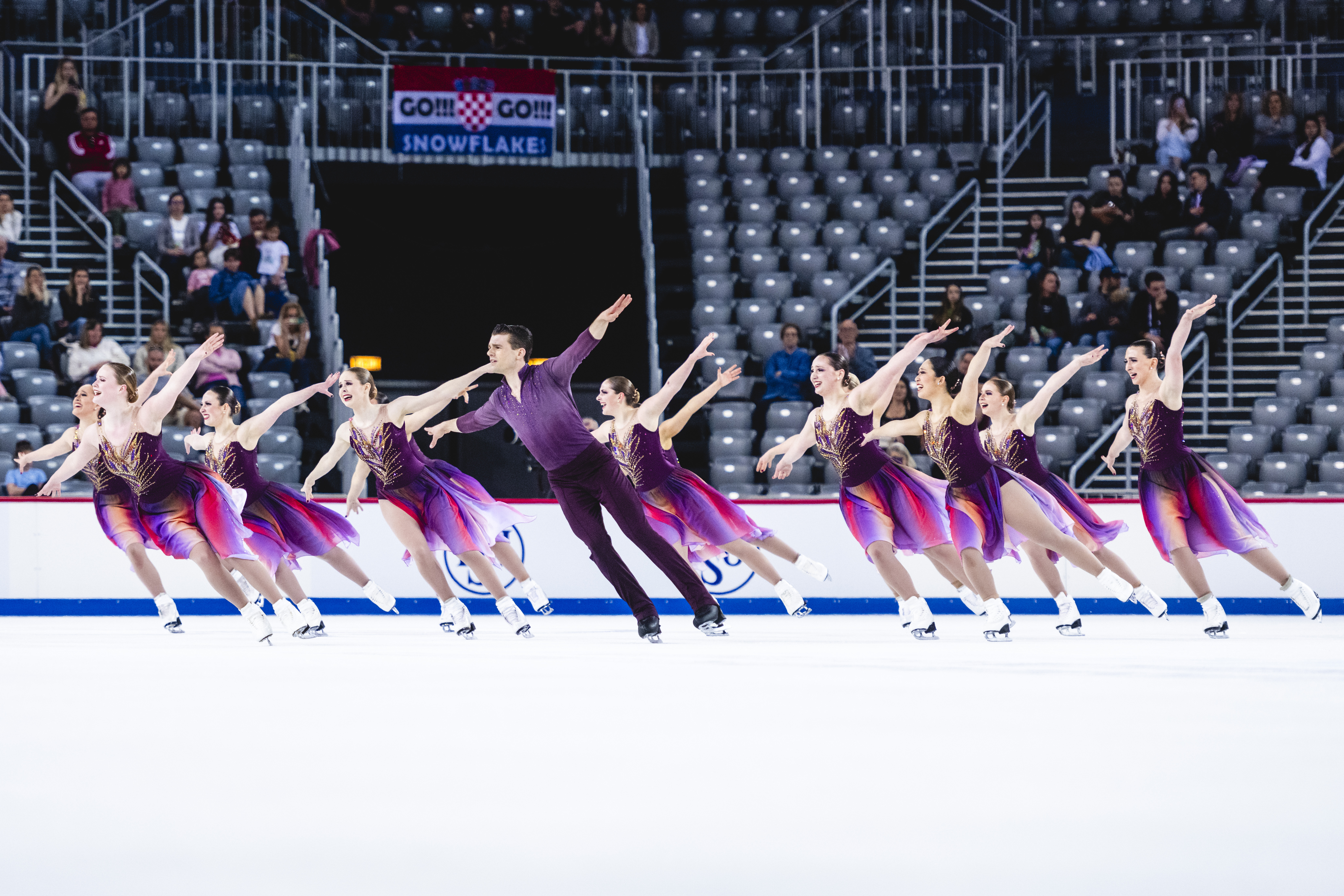 The purple-clad Haydenettes, with arms extended, deliver a nearly flawless free skate.