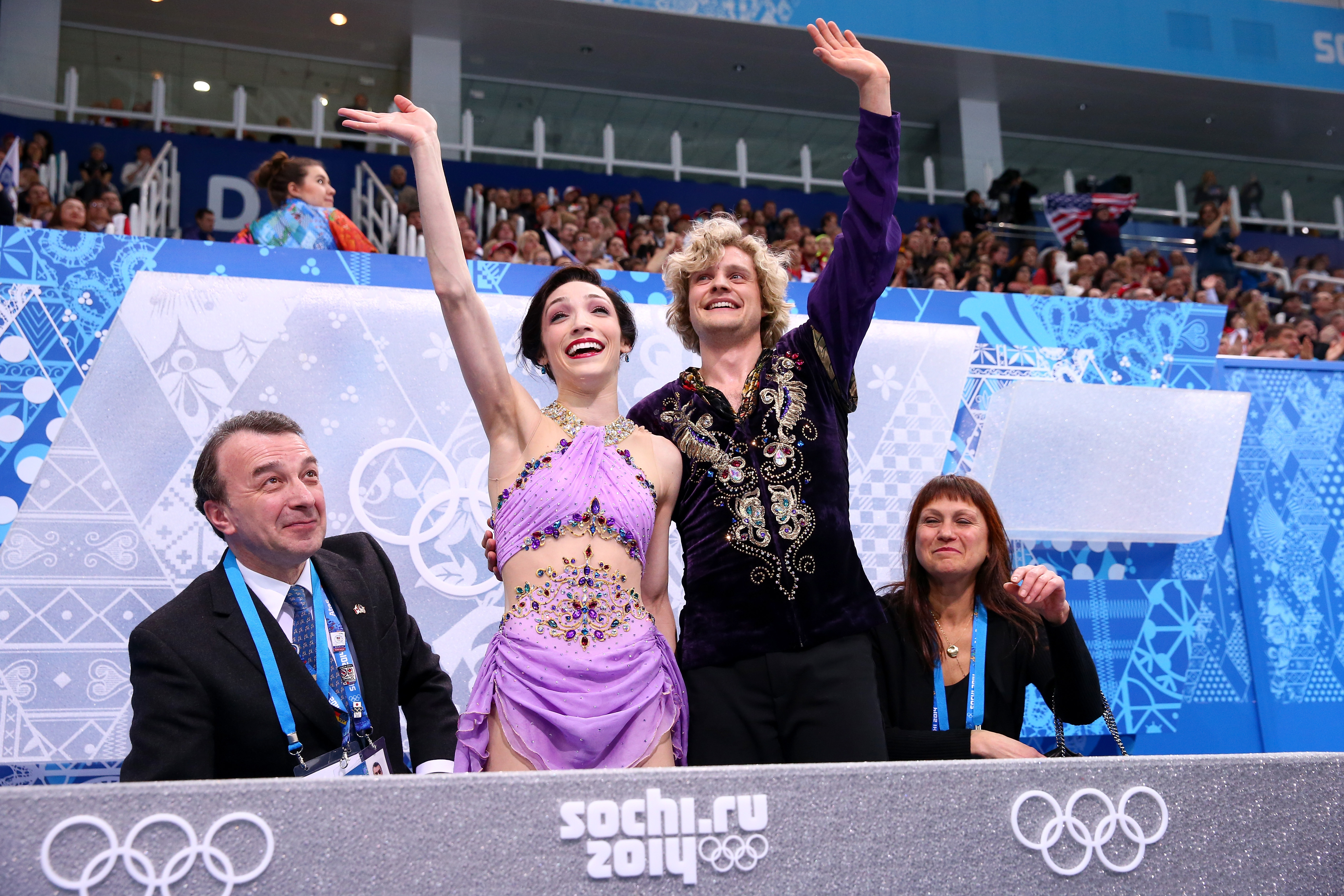 Meryl Davis and Charlie White wave from the kiss and cry at the Olympics.