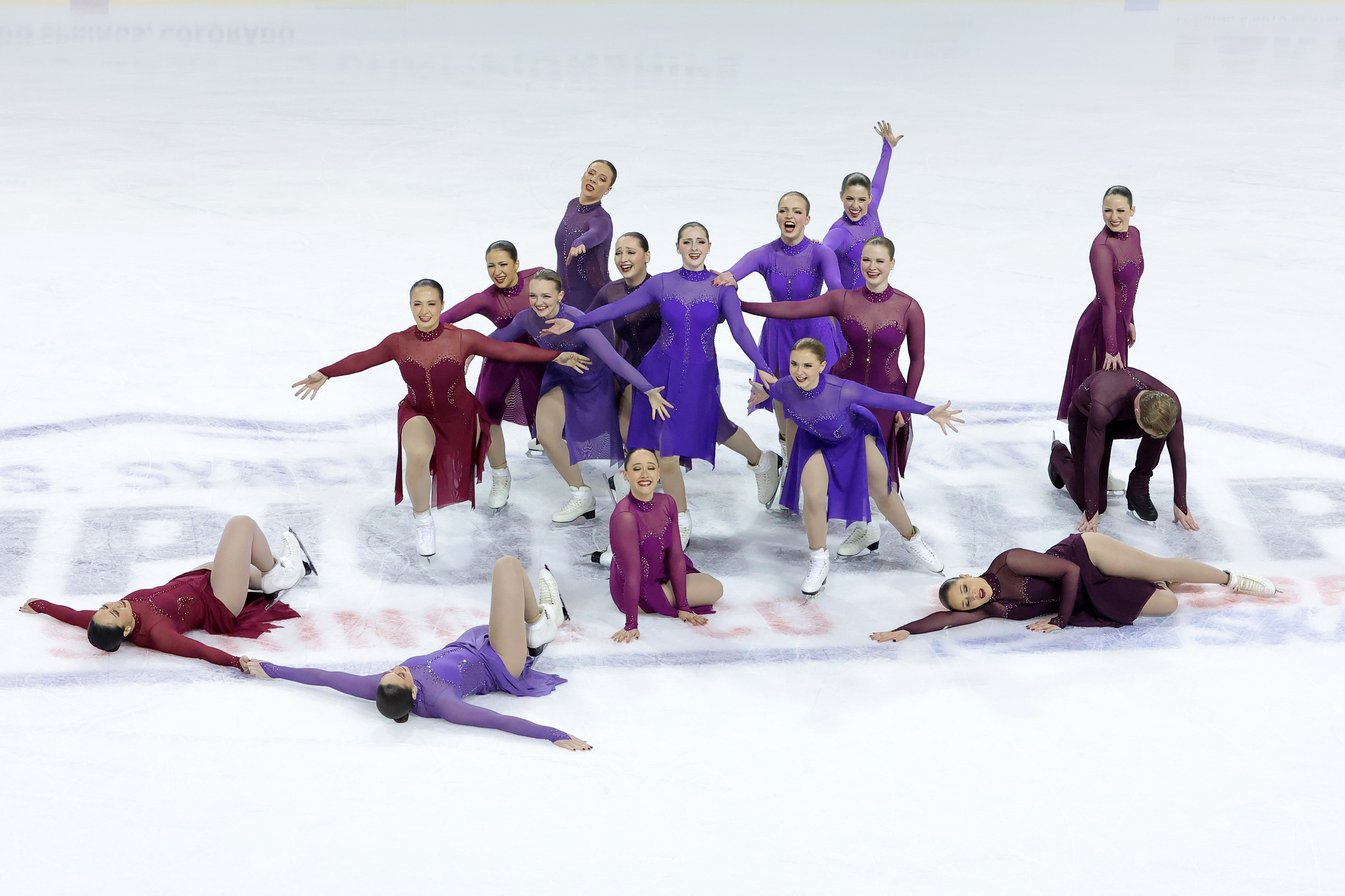 The Haydenettes, dressed in purple and red, finish their free skate at center ice.