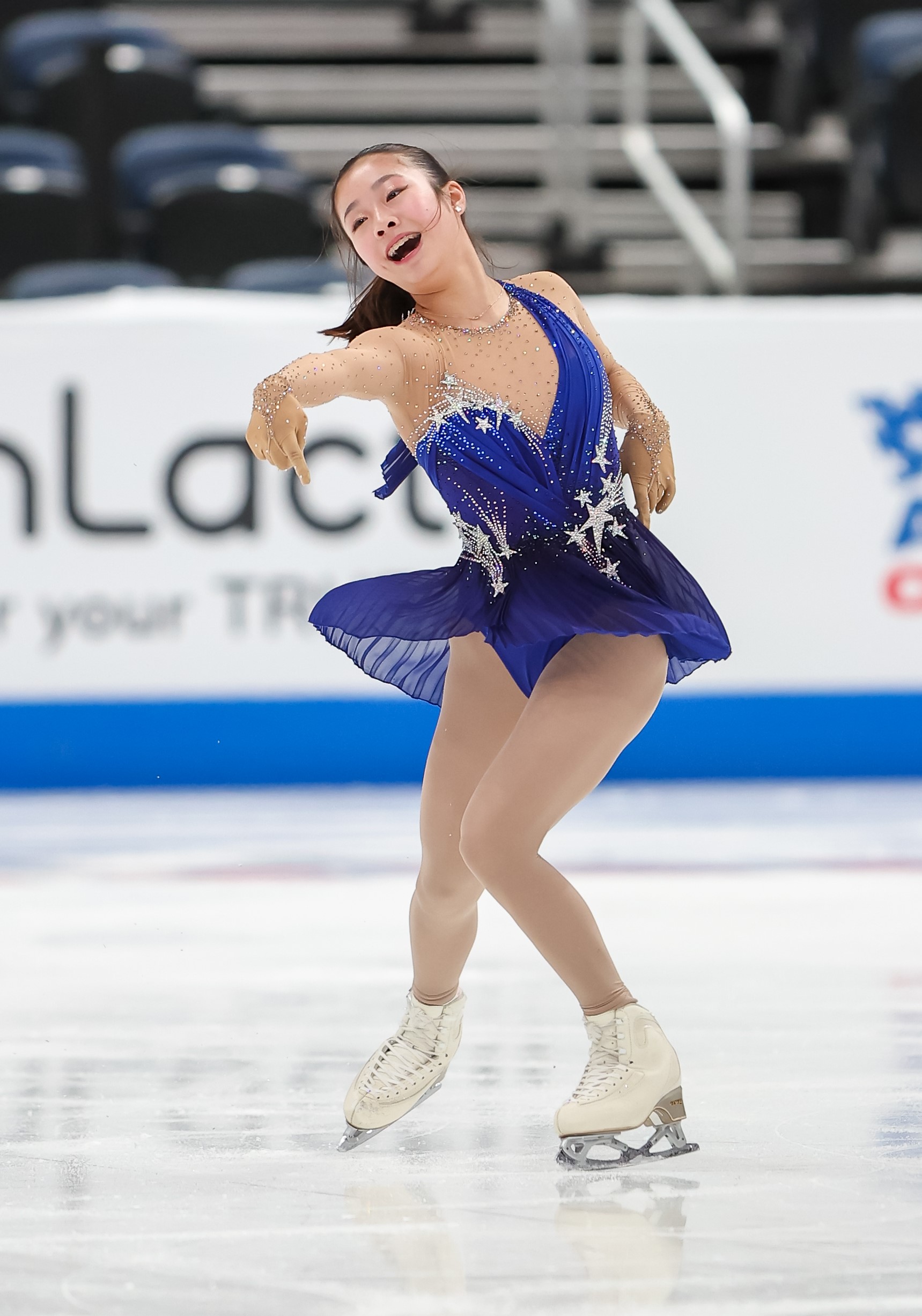 Dressed in a blue costume with stars, Logan Higase-Chen shows her personality on the ice.