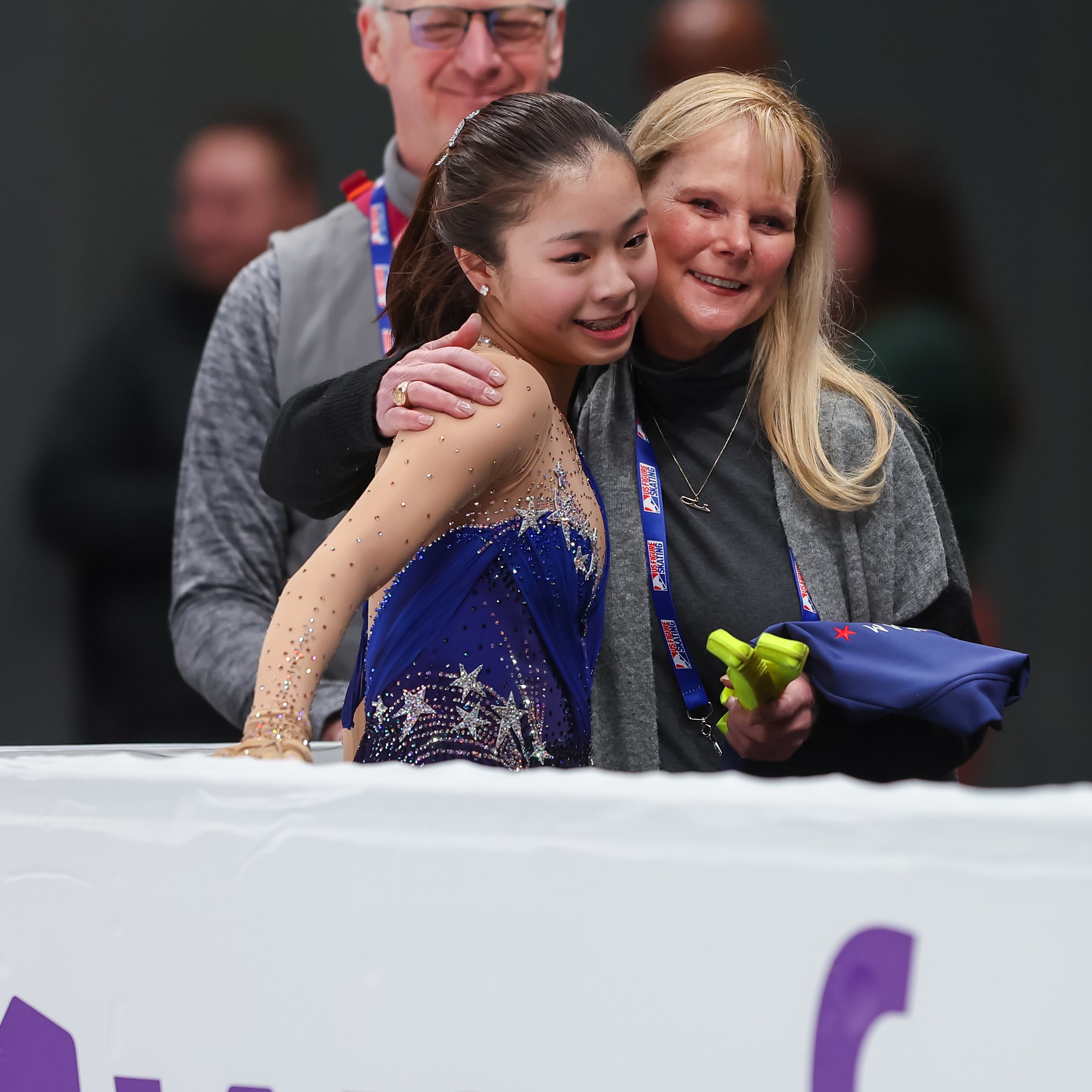 Logan Higase-Chen and coach Tammy Gambill embrace inside the kiss and cry.