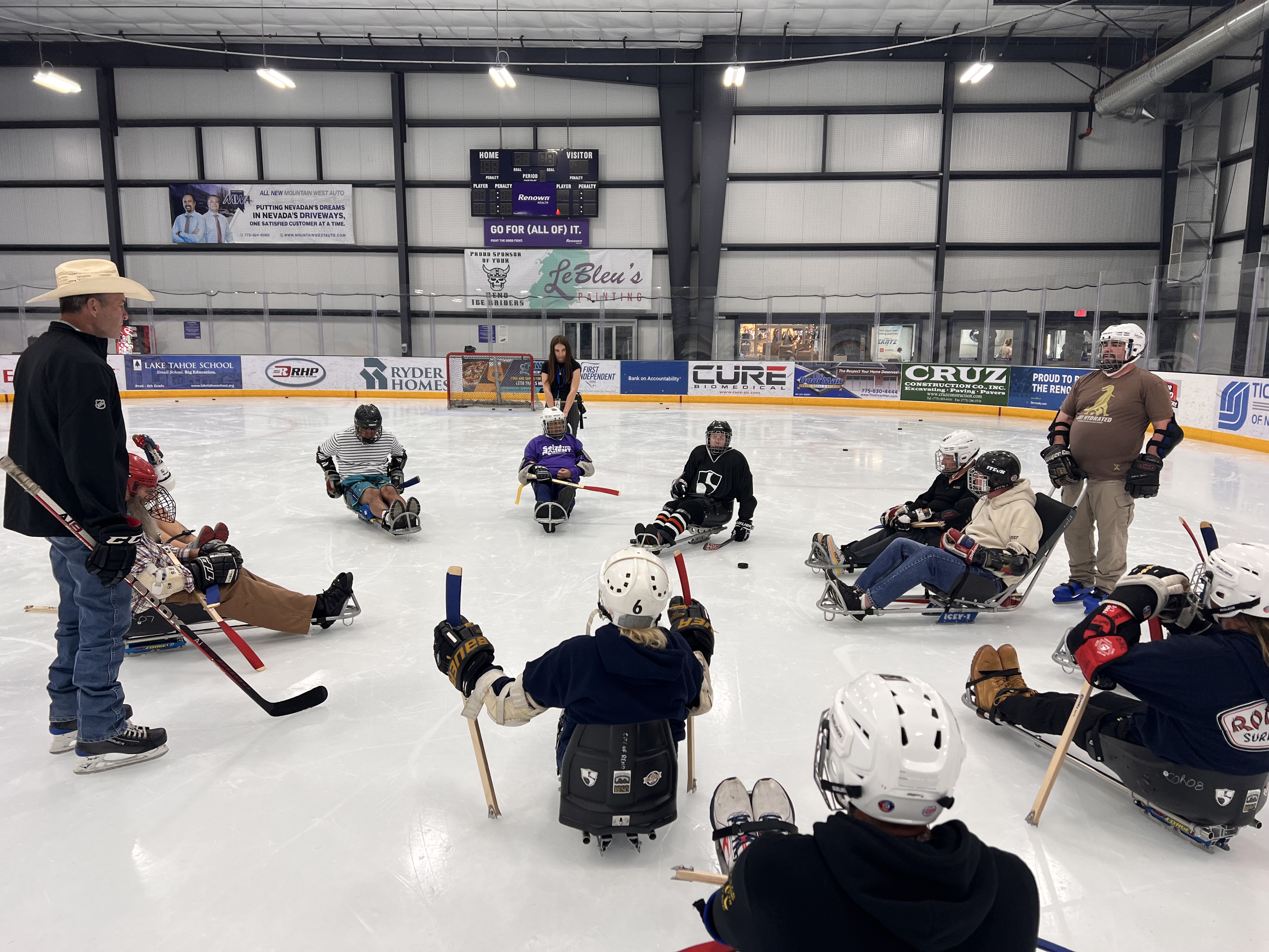Reno Ice sled hockey players get ready to practice.