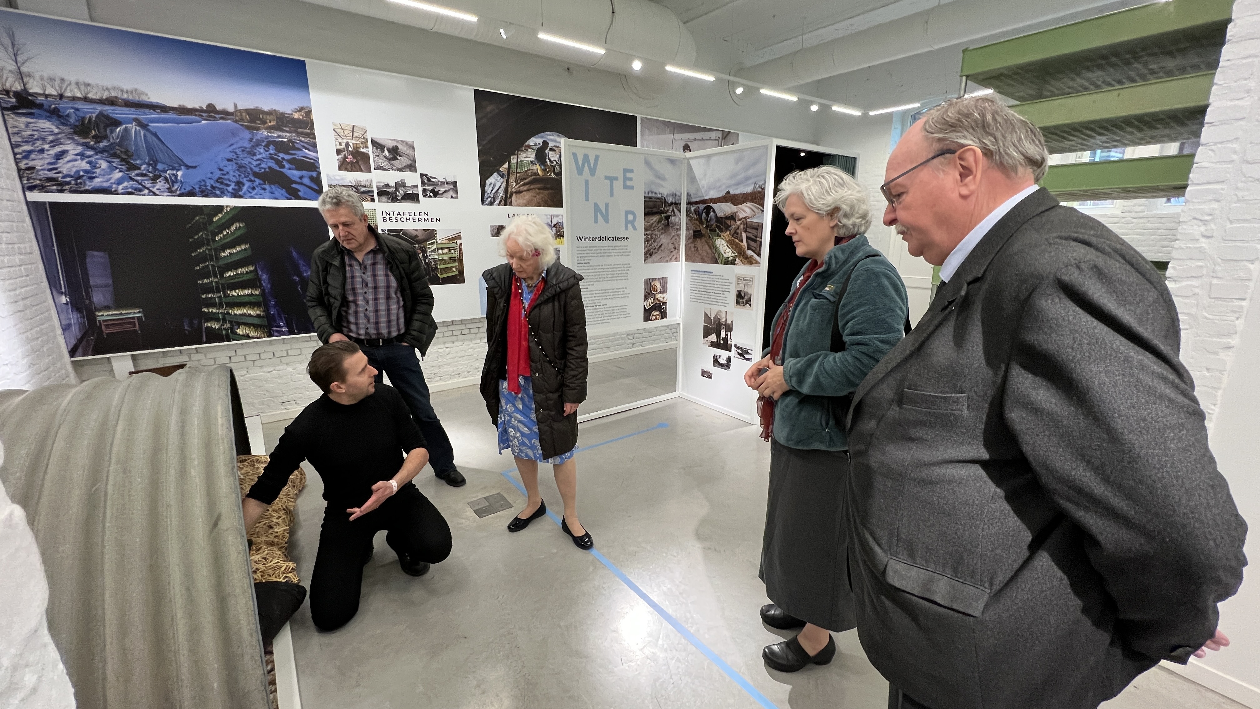 Members of the local delegation show Albright and Gardiner an exhibit that tells the story of the 1961 crash. The exhibit was recently on display at a new community center in the neighborhood where the accident occurred.