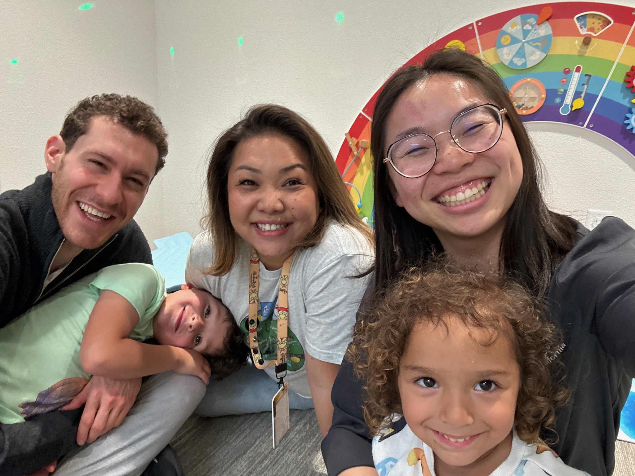Jason Brown shares a fun moment with a family staying at a Ronald McDonald House. Everyone is smiling.
