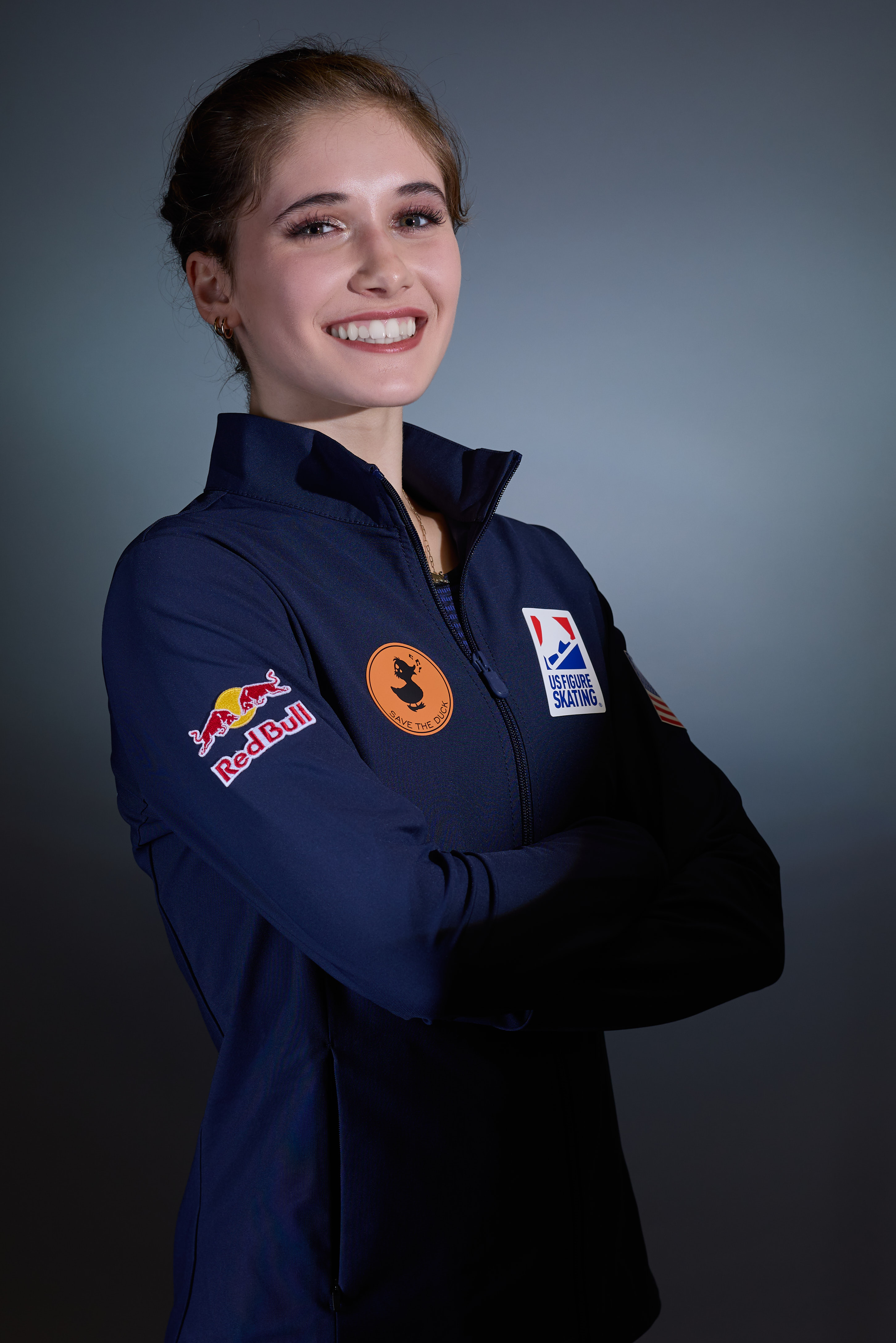 Isabeau has a big smile, wearing her blue U.S. National Team jacket.