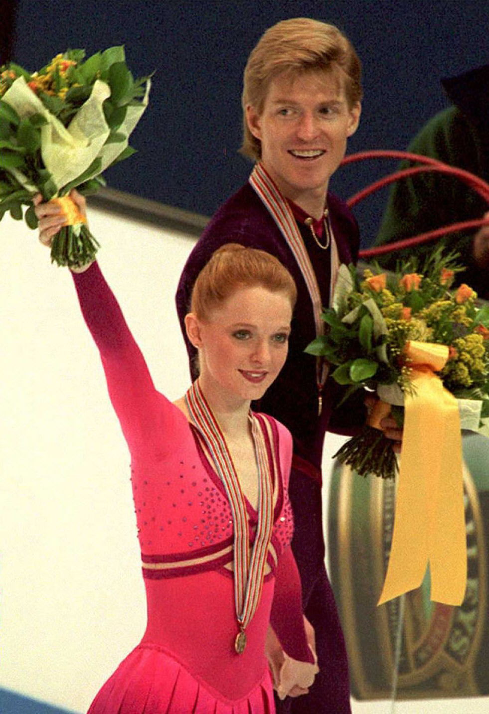 Bronze medalists of the World Figure Skating Championships pairs competition Jenni Meno and Todd Sand of the US wave as they leave the rink after the medals ceremony 08 March.