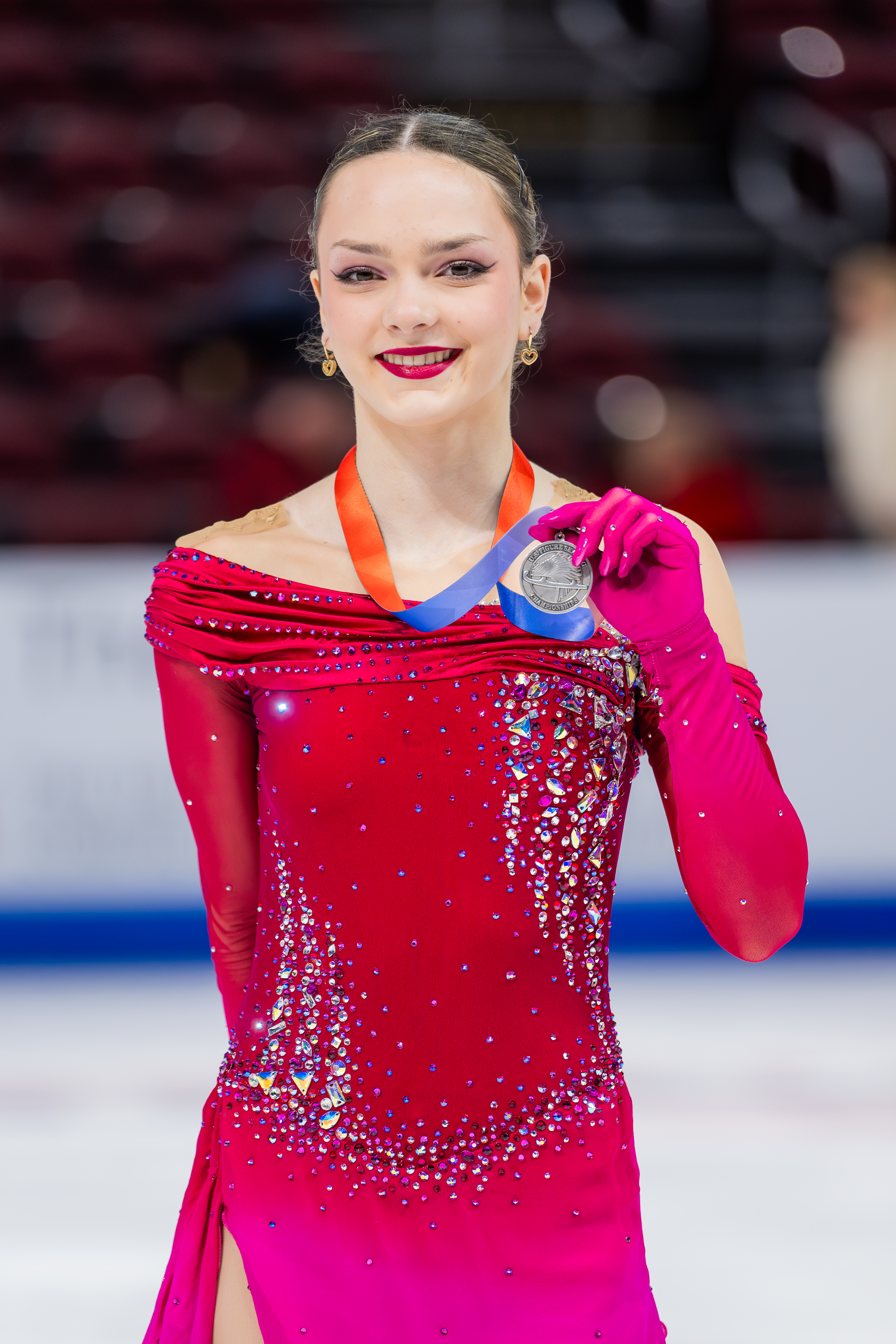 Emilia Nemirovsky, dressed in red, wears the pewter medal at the 2025 U.S. Championships