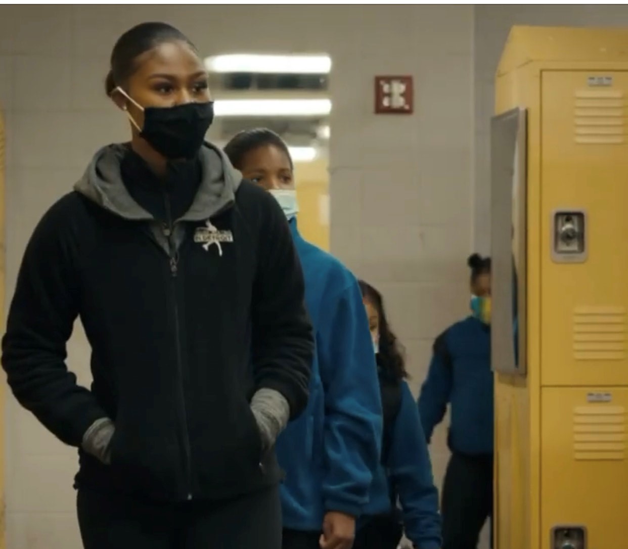 A video still of Kameryn Everett wearing a mask.