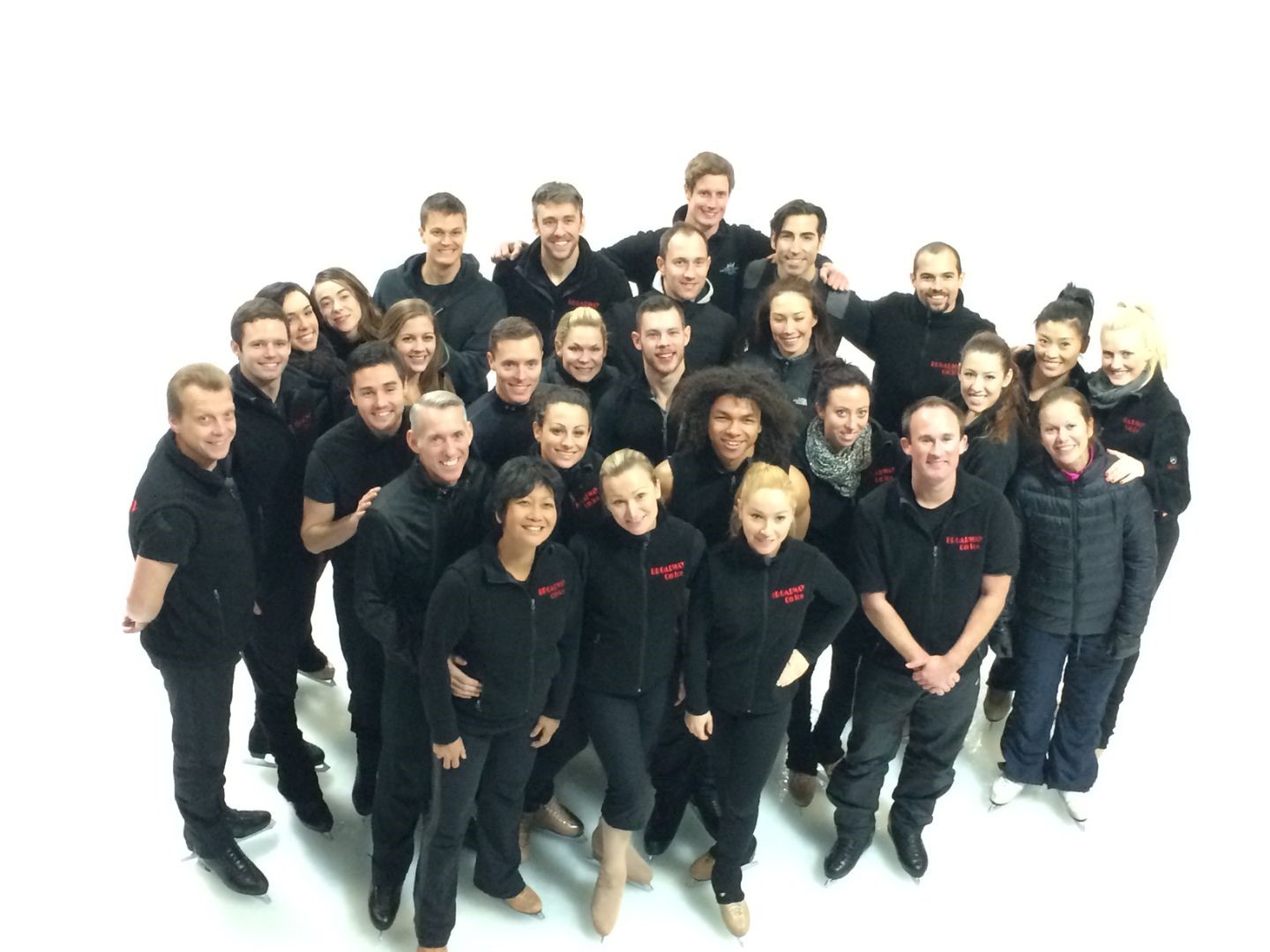 A group shot of skaters in all black featuring Sarah Kawahara.