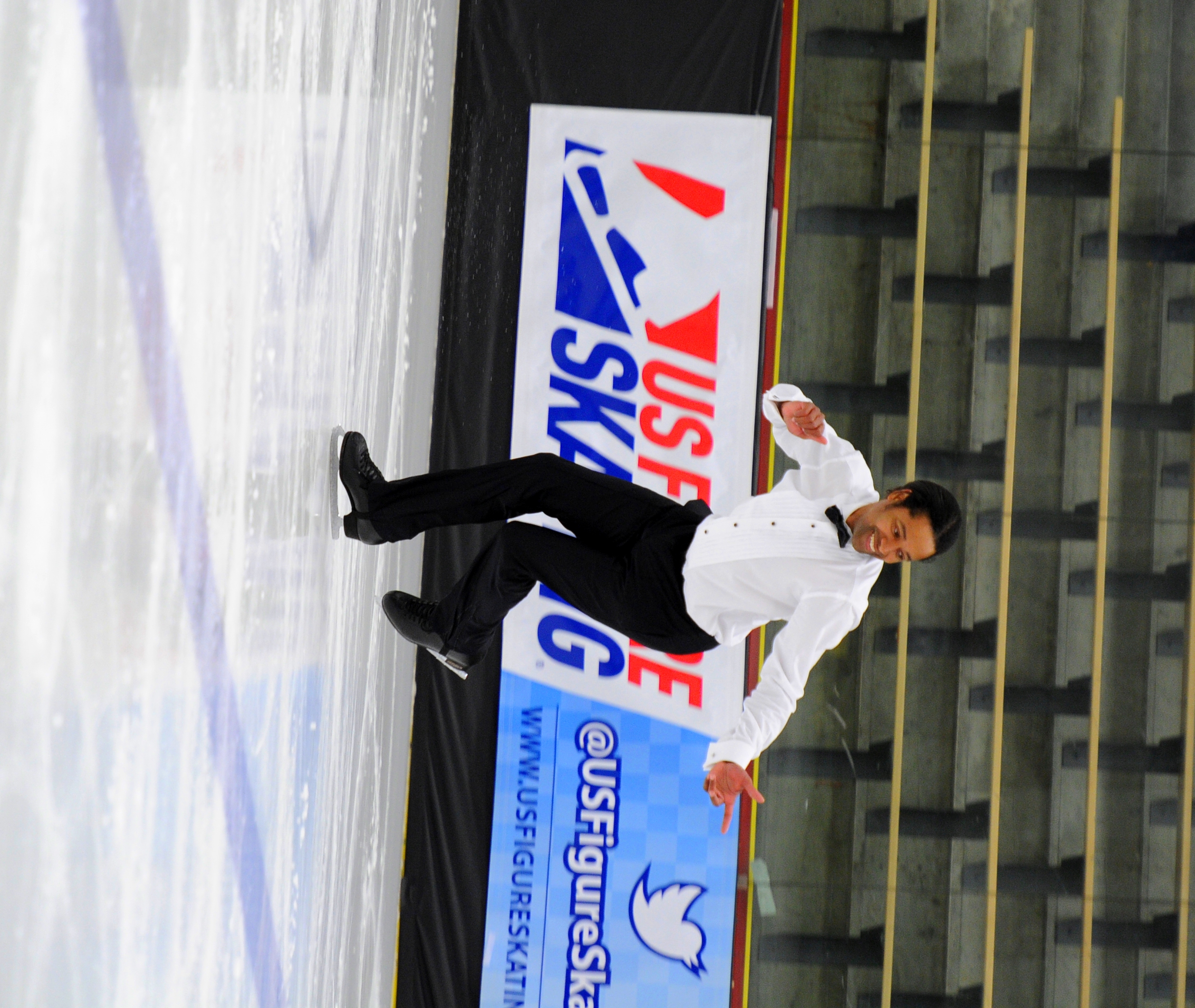 Larry Holliday skating in a white shirt and bowtie.