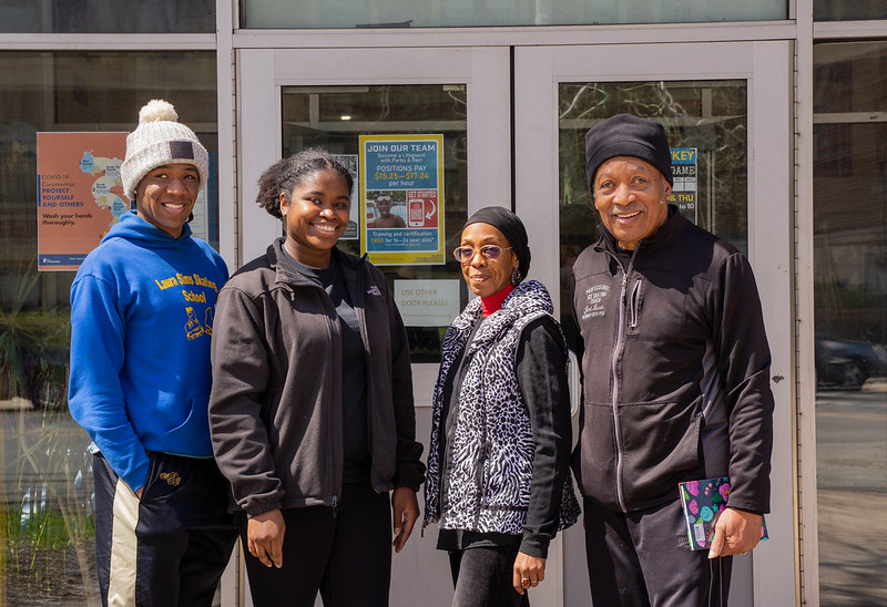 Johansson Jones, Jayda Jones, coach Sultana Muhammad and coach Jimi Lewis stand in front of the Laura Sims Skate House entrance.