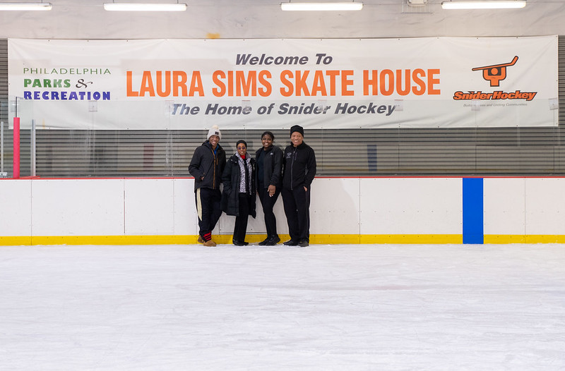 Johansson Jones, coach Sultana Muhammad, Jayda Jones and coach Jimi Lewis stand on the ice.