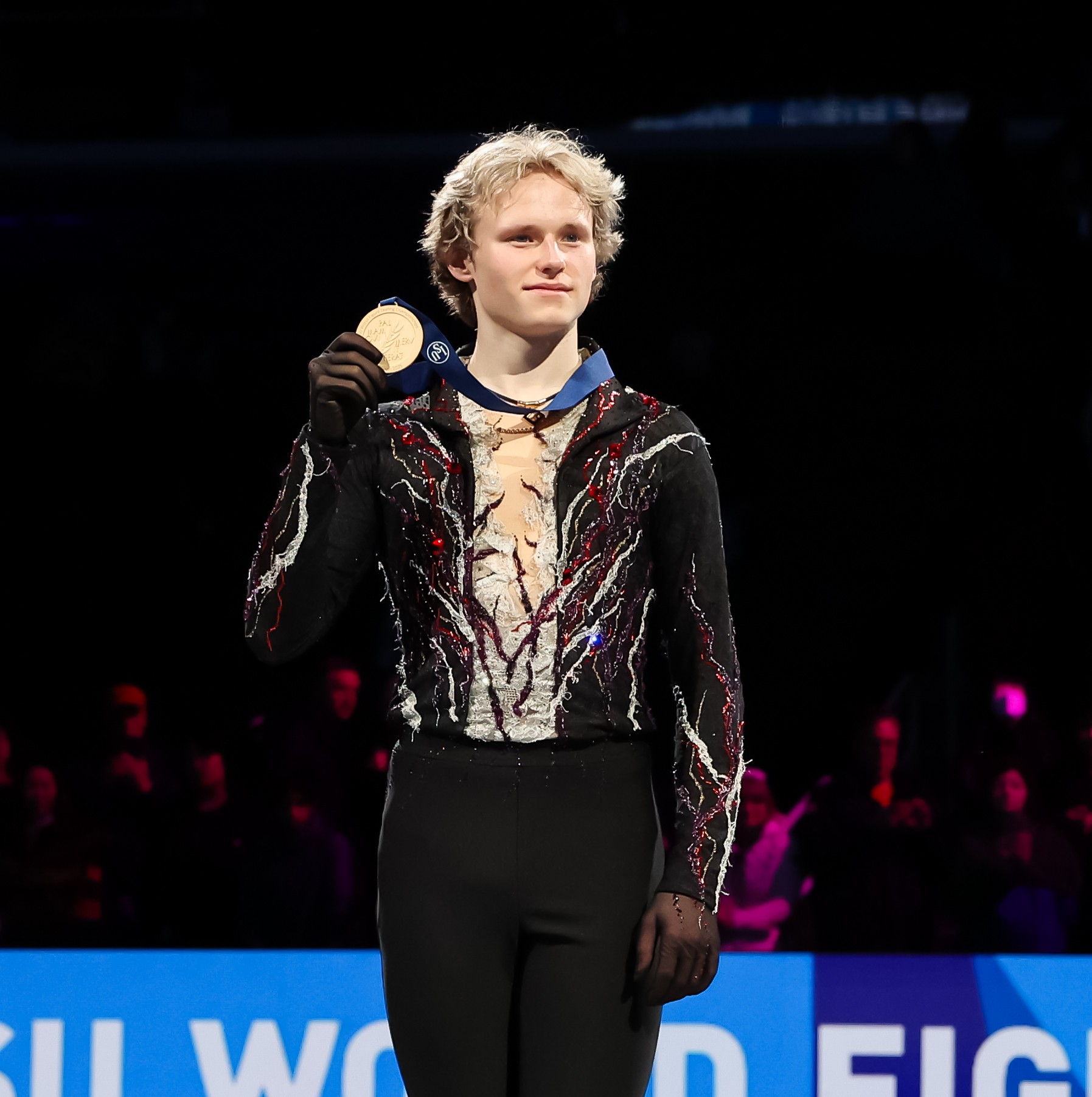 Ilia Malinin holds up his gold medal during the victory ceremony at the 2025 World Championships.