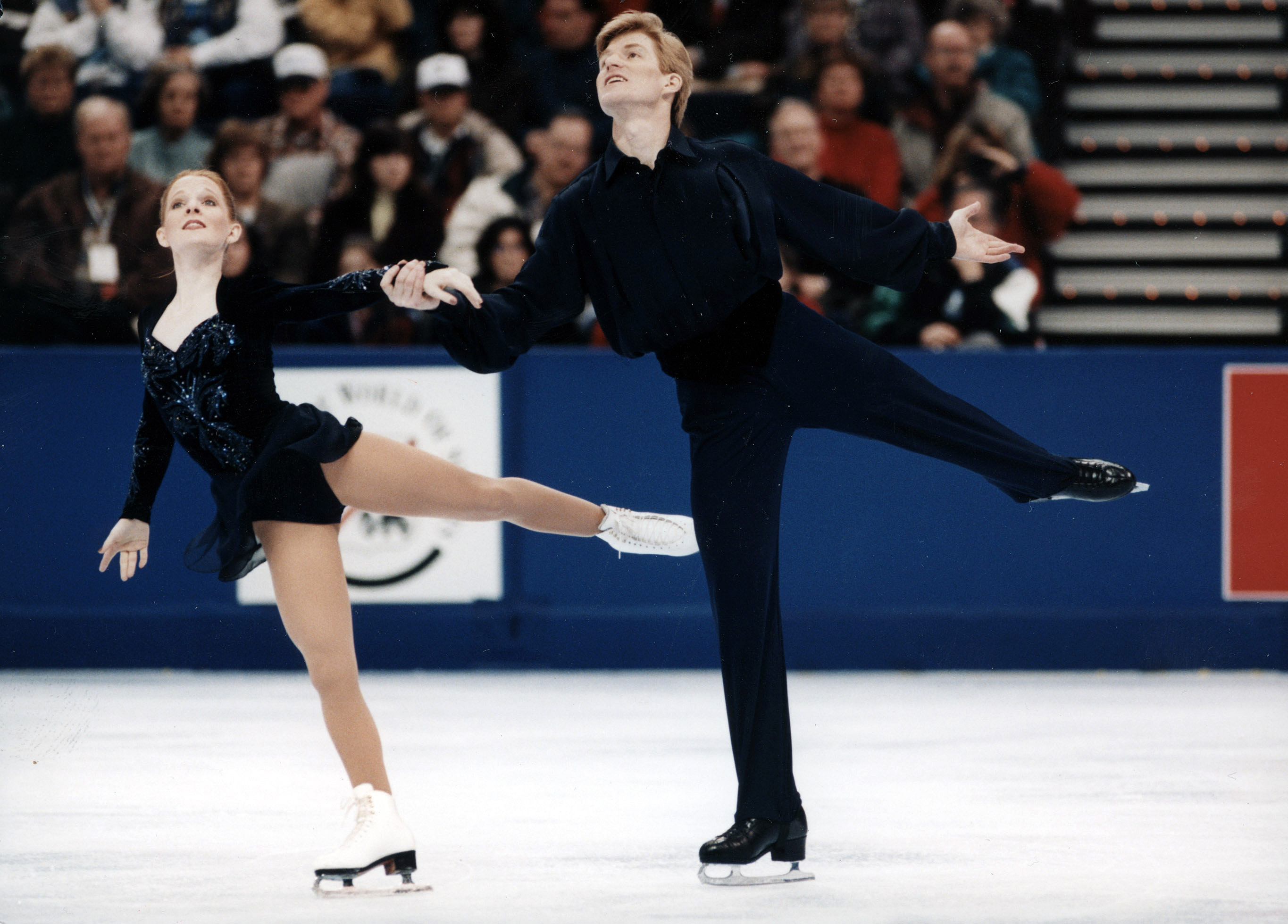 Jenni Meno and Todd Sand skate together in black costumes