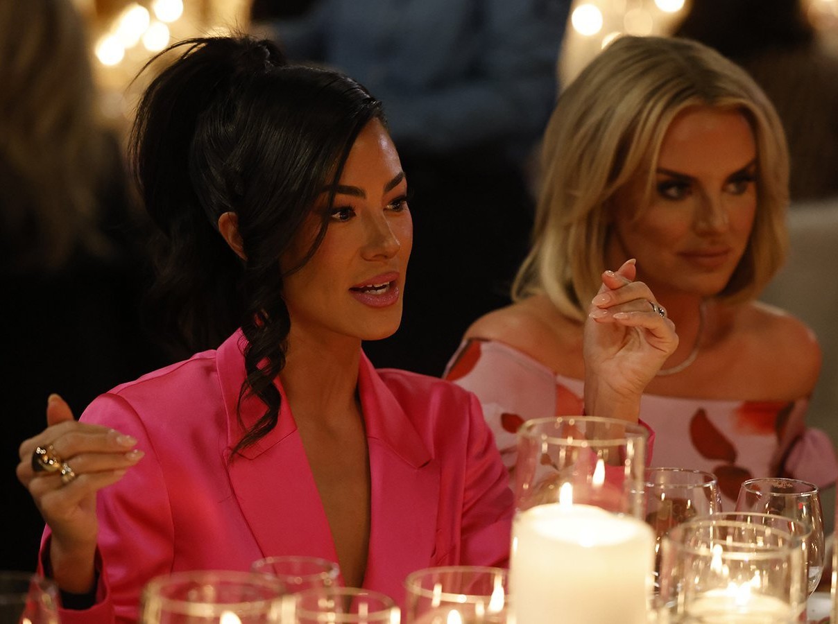 Sitting at a dining table outside, Meili Workman, donning a pink dress, stars in Bravo's Real Housewives of Salt Lake City.