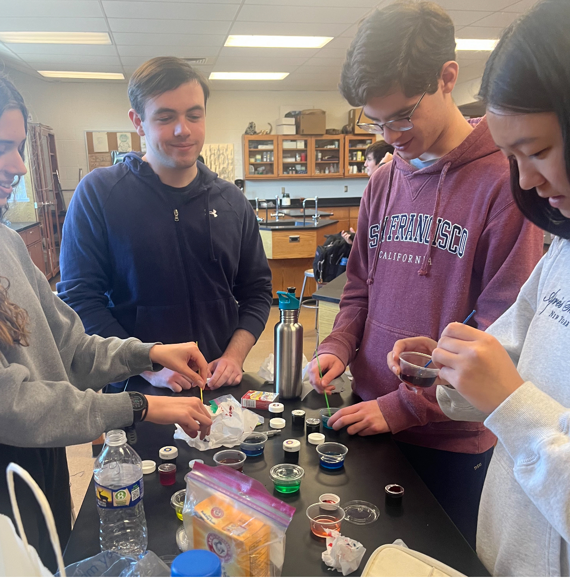 Julia Ran, right, works with classmates on a science experiment to share with younger students.