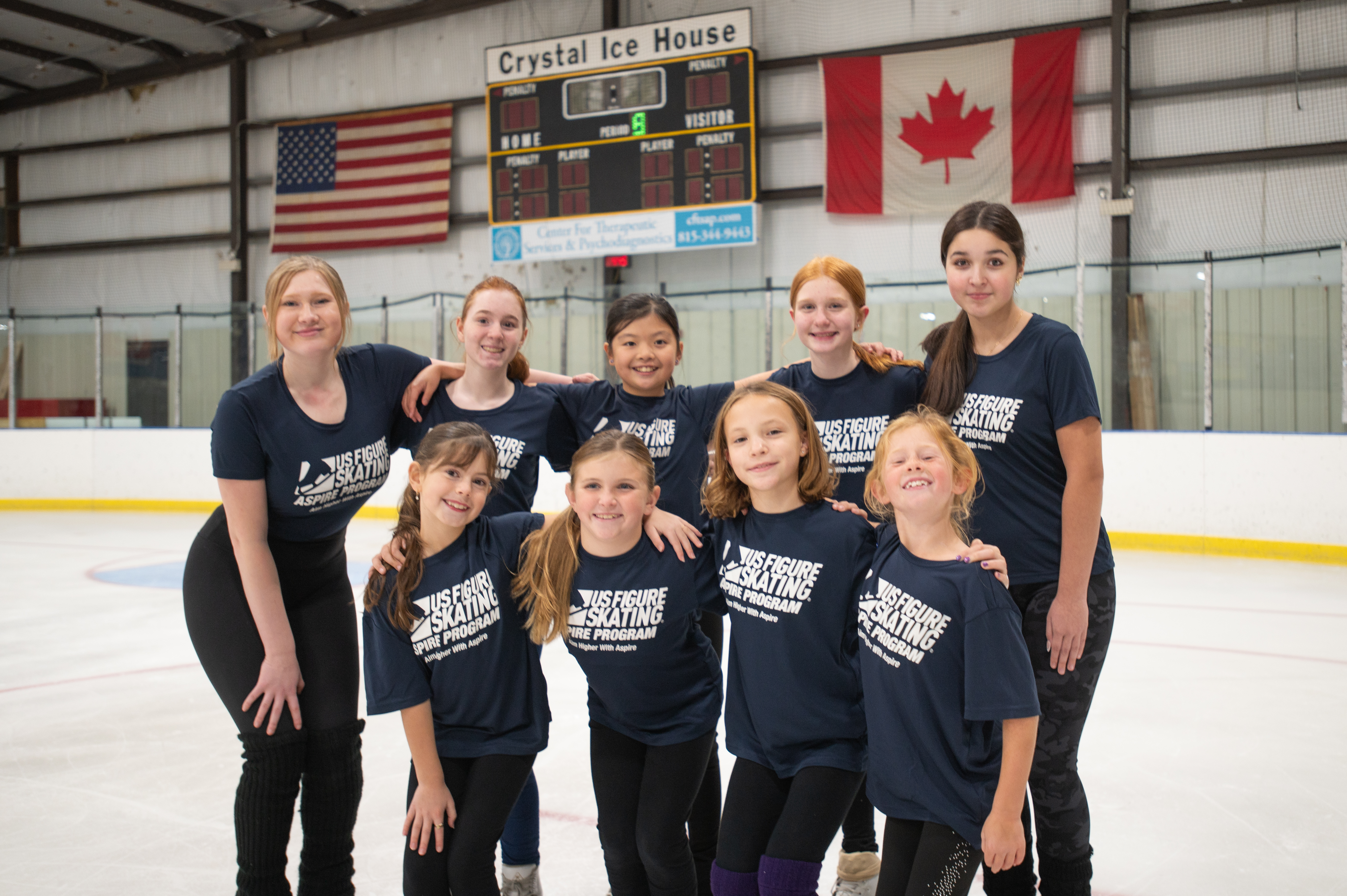 Nine young skaters showcase their blue Aspire T-shirts. 