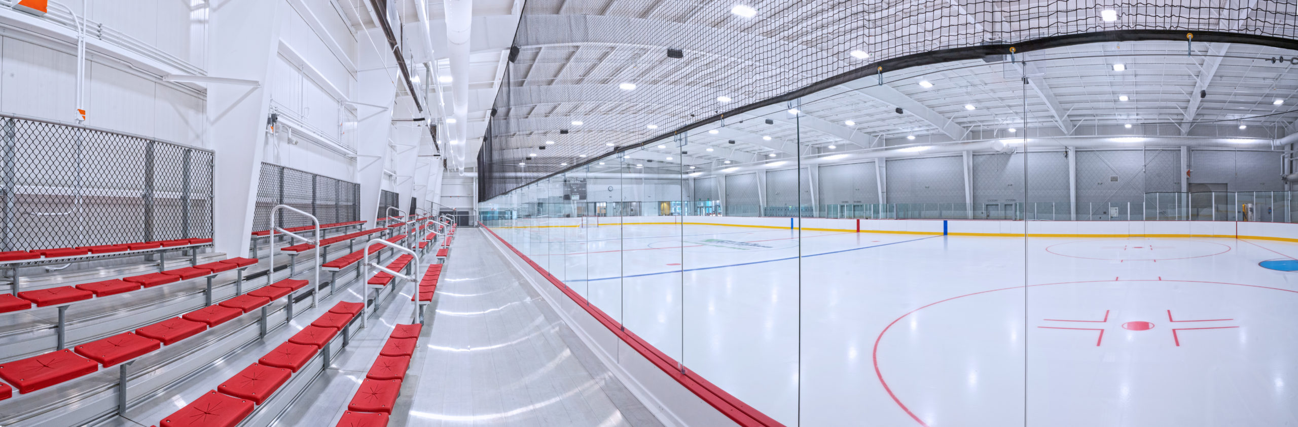 A wide shot of the brightly lit ice rink at Tucker Road