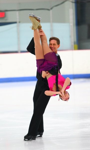 Walter lifts his partner in the air by her ankles