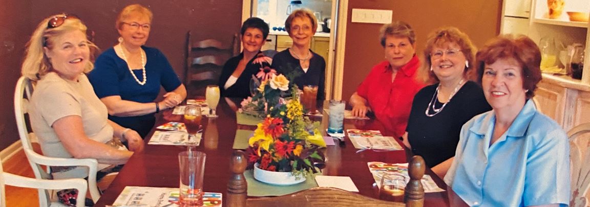 Members of Wendy's Lunch Bunch sit around a dinner table.