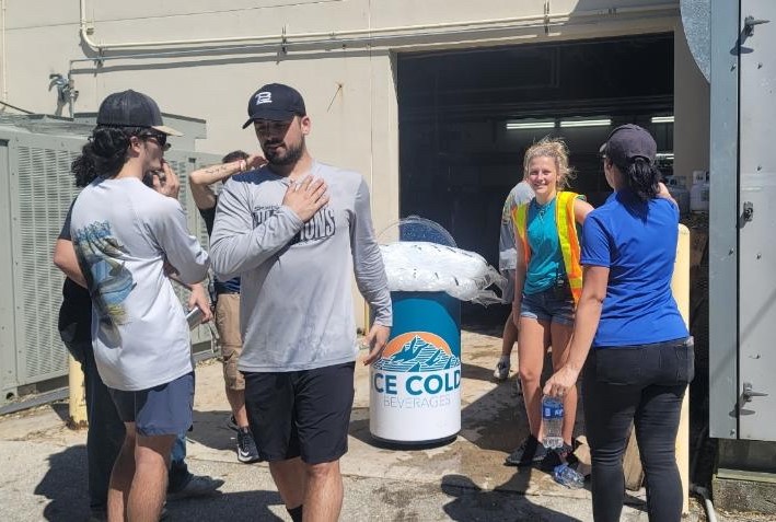 City of Palms Skating Club volunteers unload boxes of donations at the Fort Myers Skatium.