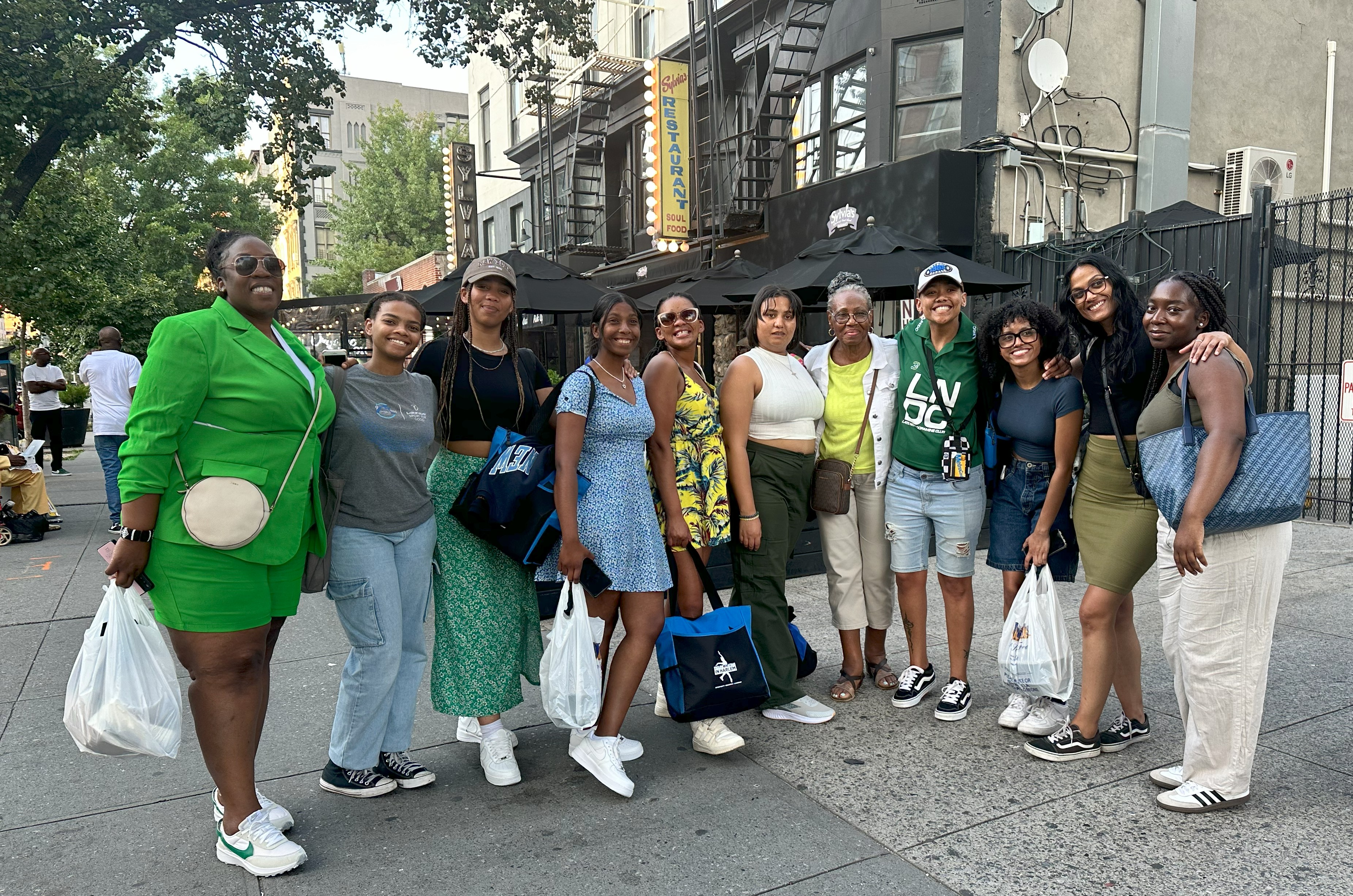 A group from the 9Miles Project in South Africa stand outside the famed Sylvia's Restaurant.