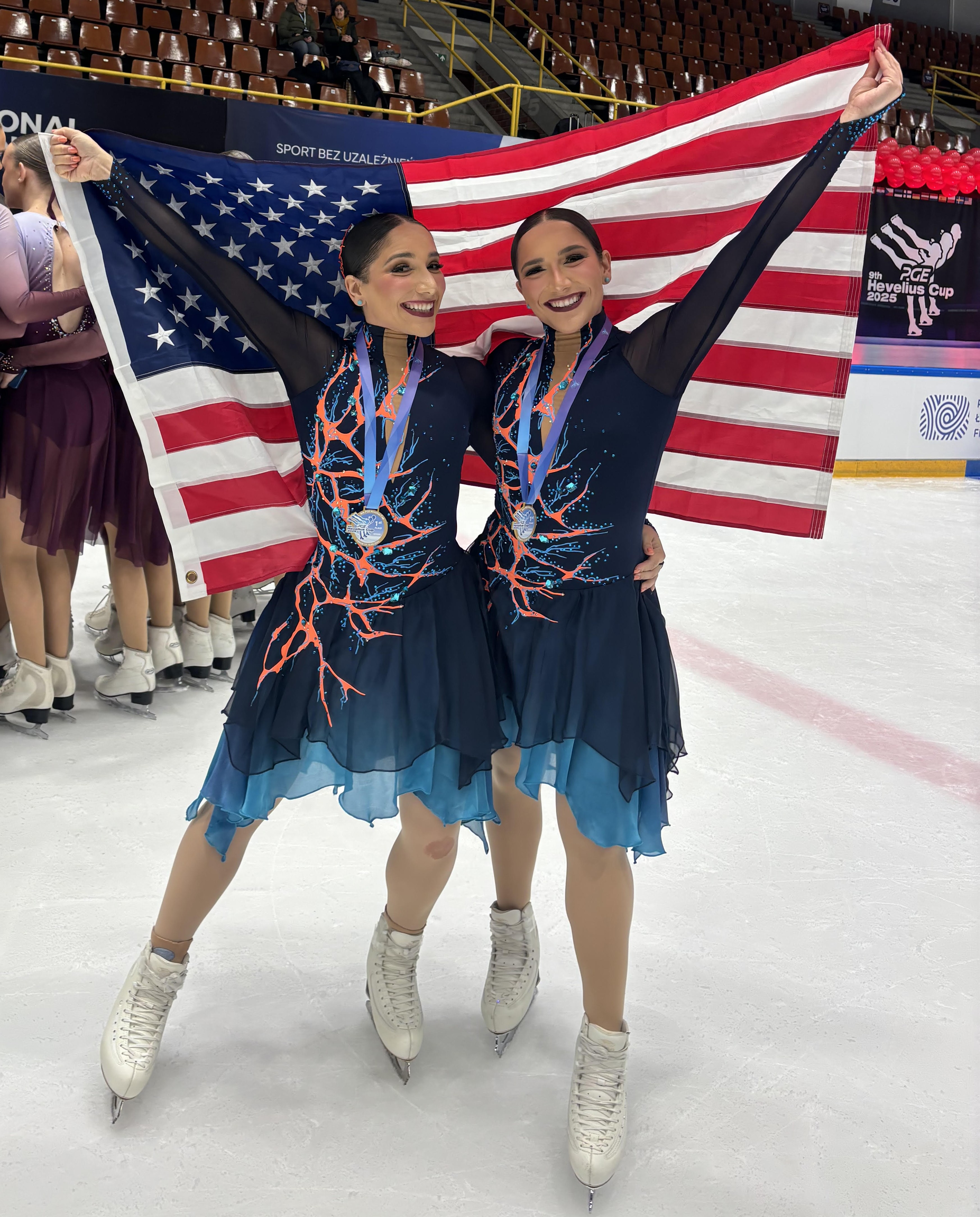 Nicole and Victoria Buddie hold up the American flag after Hayden Select won the 2025 Hevelius Cup in Poland.