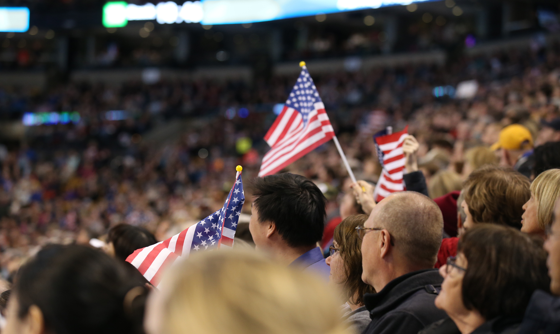 Picture of American flag sticking out among a sea of fans.