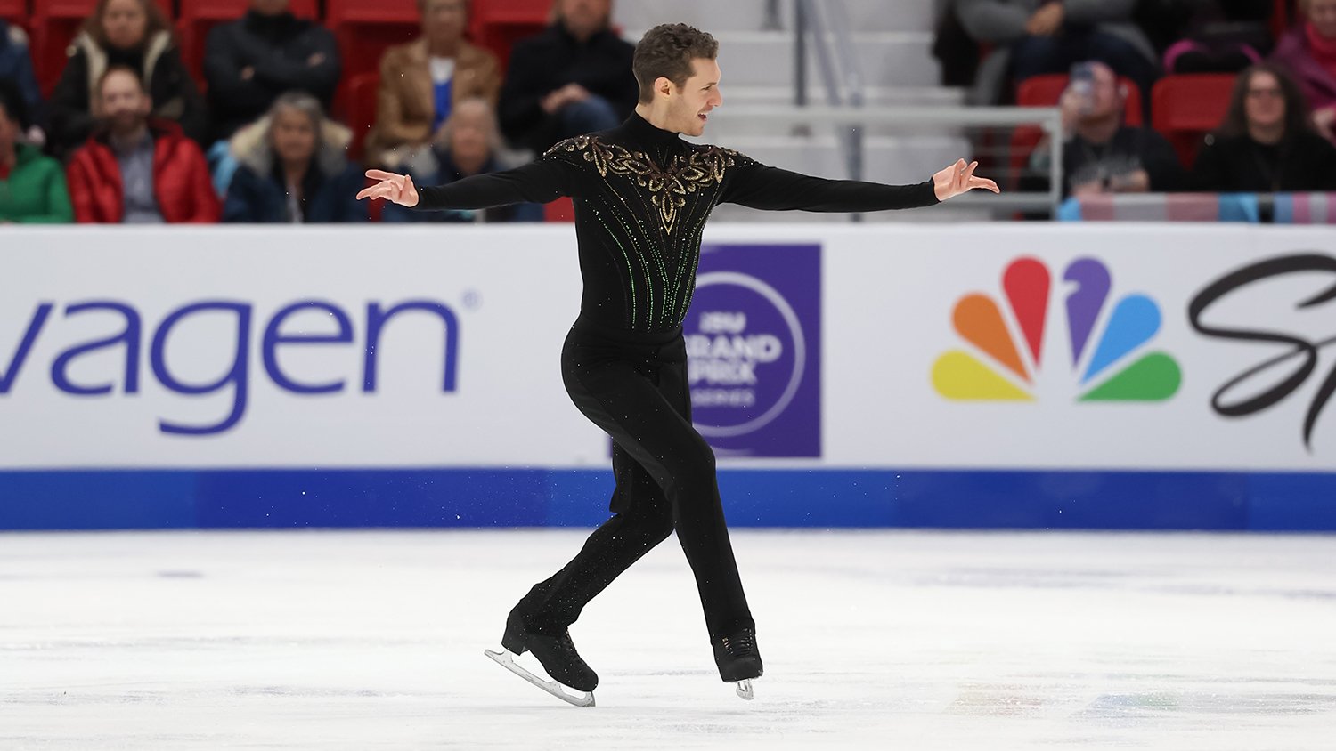 Jason Brown, wearing all black with gold and green detail on the chest, performs "Riverdance" at Skate America.
