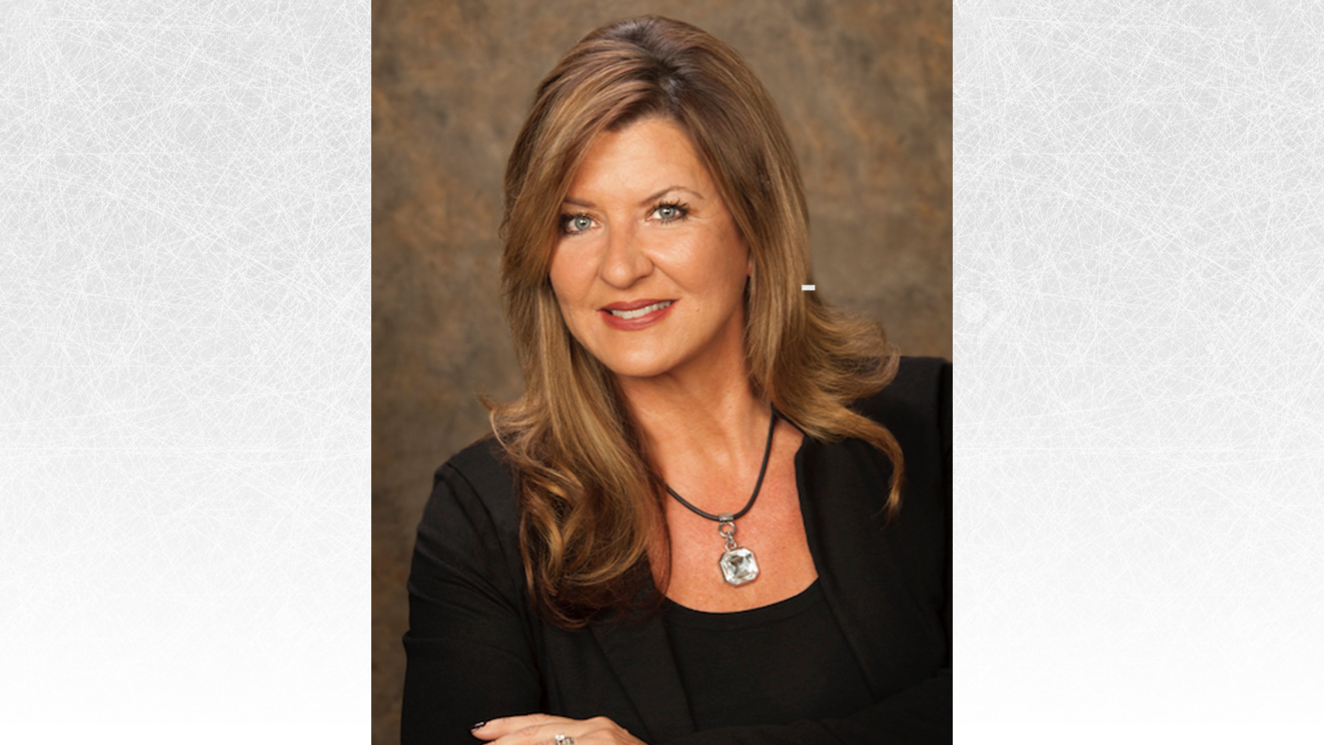 headshot of Steffany Hanlen. She is an older woman with long brown hair wearing a black shirt with a black blazer over top and a crystal necklace