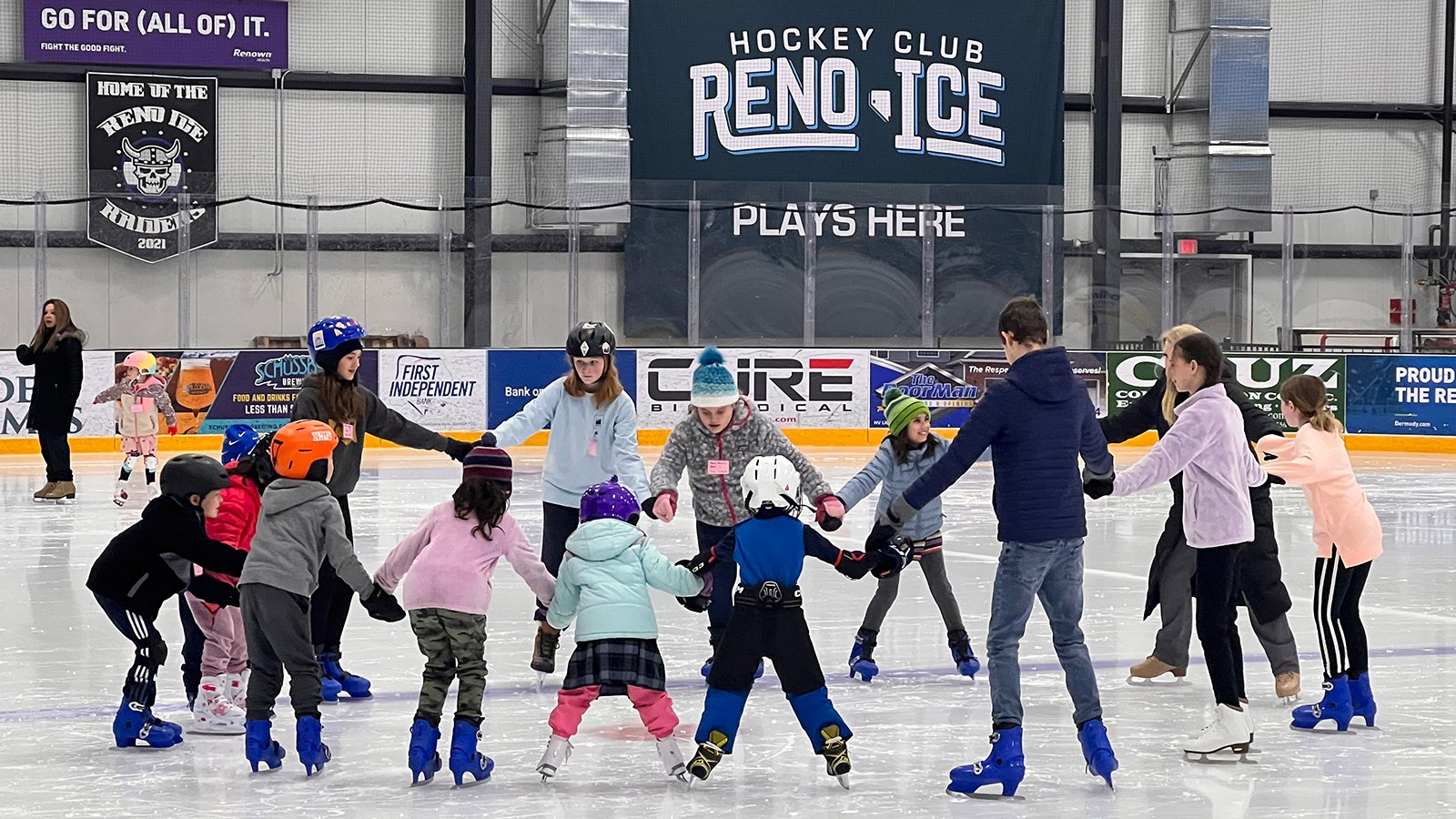 A group of young skaters form a circle to work on their skating skills at Reno Ice.