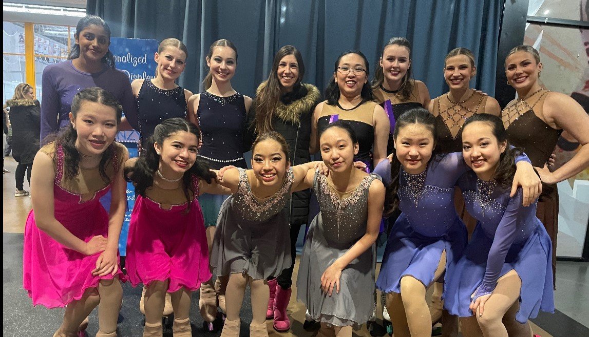 Naomi Lang (center( poses with her solo dance team