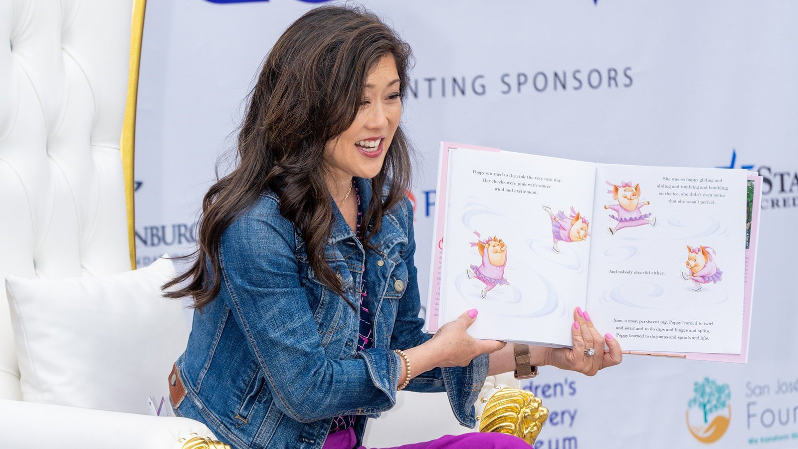 Olympic champion Kristi Yamaguchi holds a book open as she reads to children. 