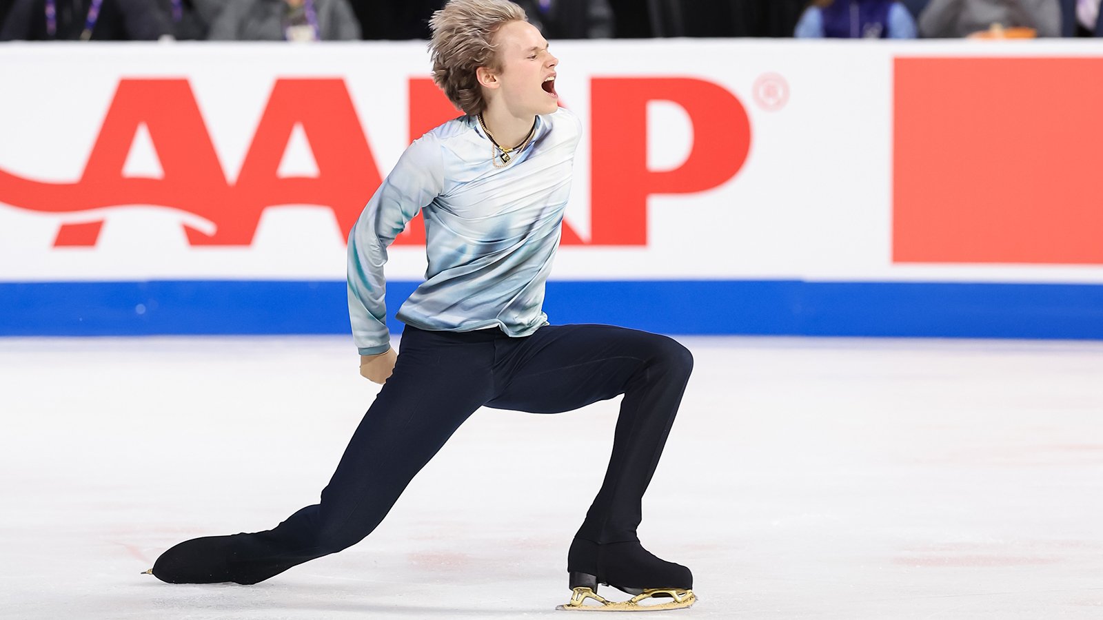 Wearing a white top with long sleeves, with black pants, Ilia Malinin shows emotion at 2024 Skate America.