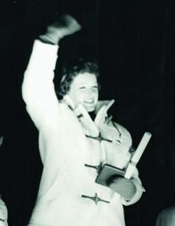 Tenley Albright waves to the crowd at her Olympic medal ceremony in 1956