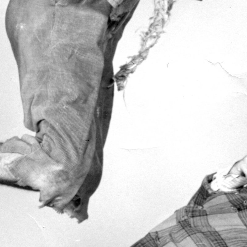 1930s show skaters Frick and Frack perform a jump and duck move together in a black and white staged photo.