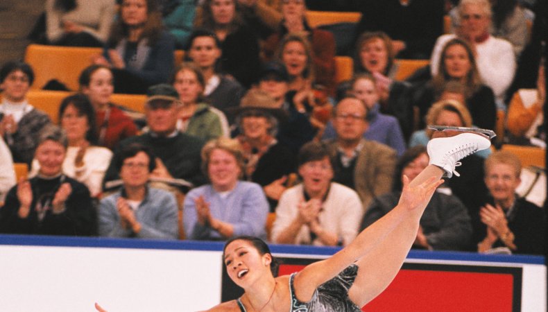 Michelle Kwan performs her legendary spiral in a gray dress.