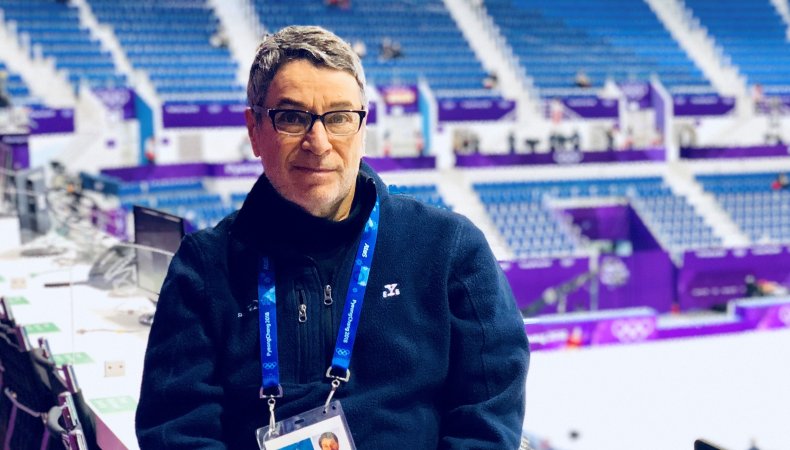 Phil Hersh sits in front of the purple rink at the 2018 Olympics.