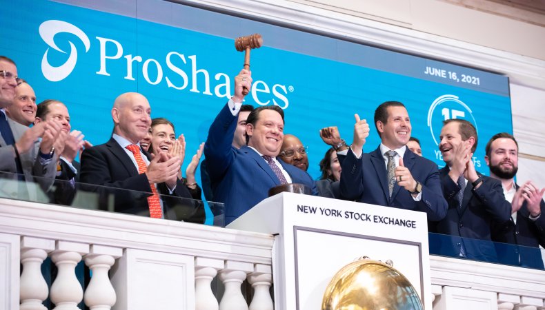 Troy Goldstein ringing the New York Stock Exchange bell among a group of colleagues.