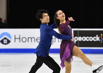 Katarina Wolfkostin and Jeffrey Chen reach in the distance while performing their junior free dance at the 2021 Toyota U.S. Figure Skating Championships.